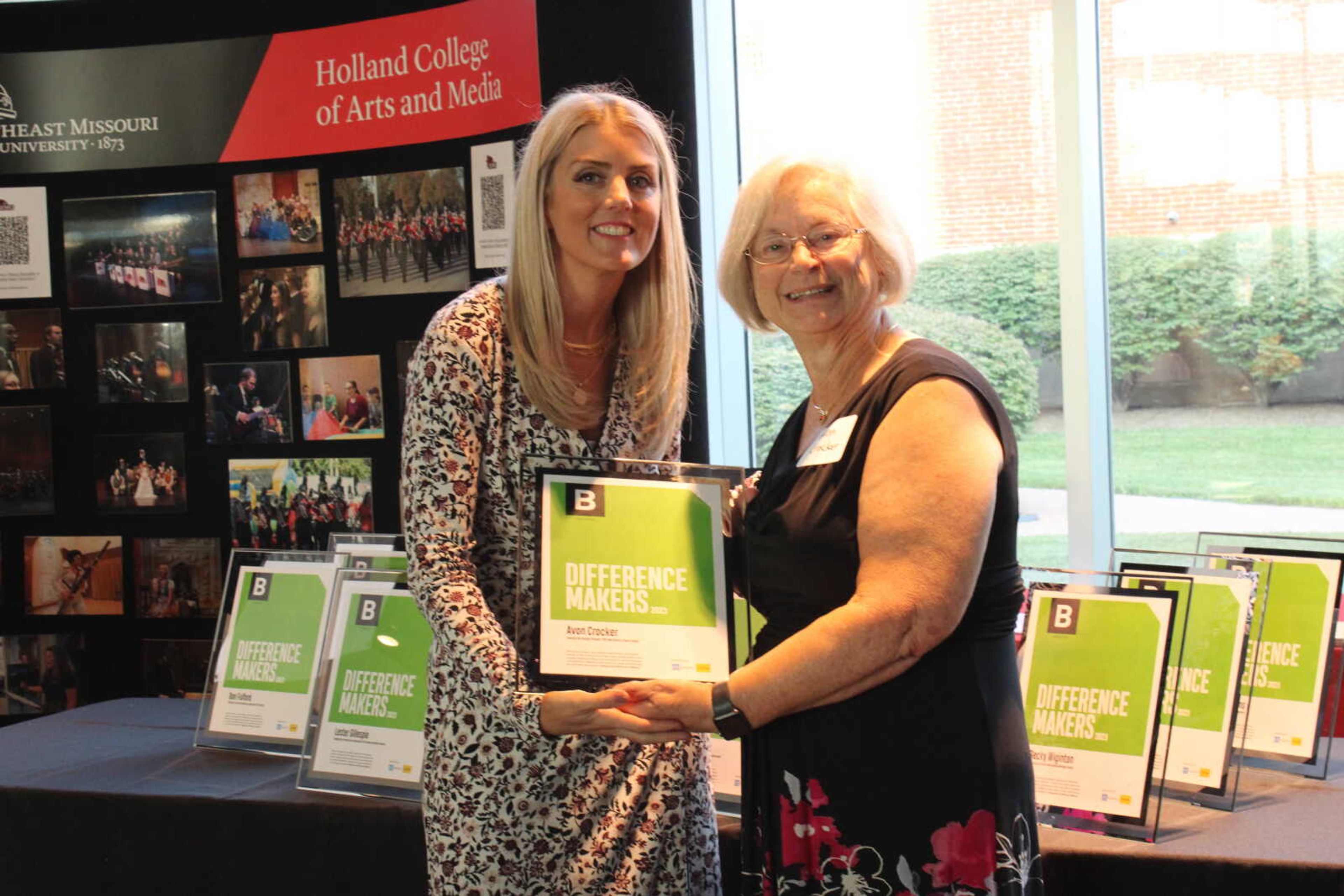 Edward Jones financial advisor Brooke Roth hands Difference Maker Avon Crocker her award.