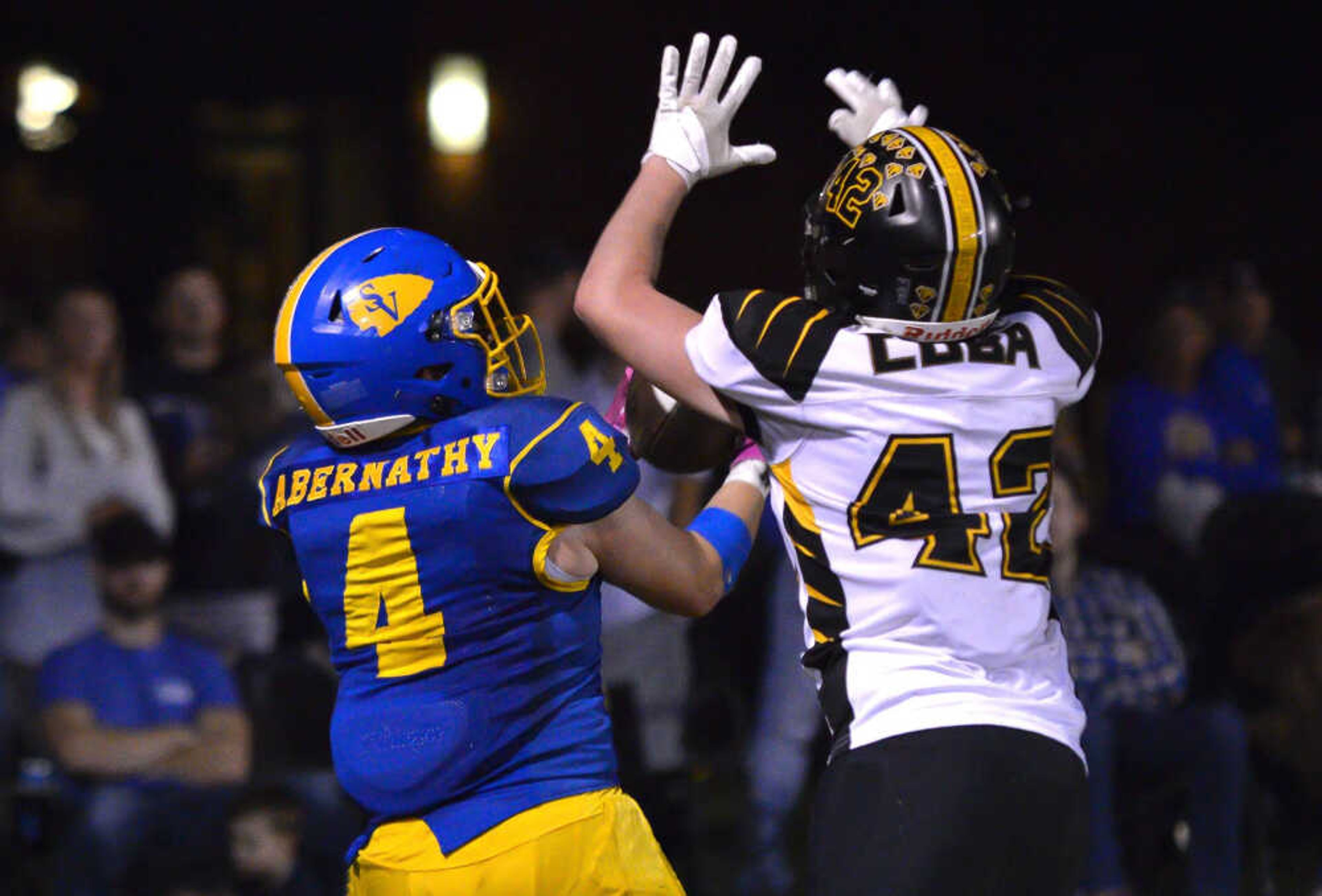 St. Vincent’s Eli Abernathy, left, reels in an over-the-shoulder catch during a game between the St. Vincent Indians and the Cuba Wildcats on Friday, Oct. 11, at St. Vincent High School in Perryville.