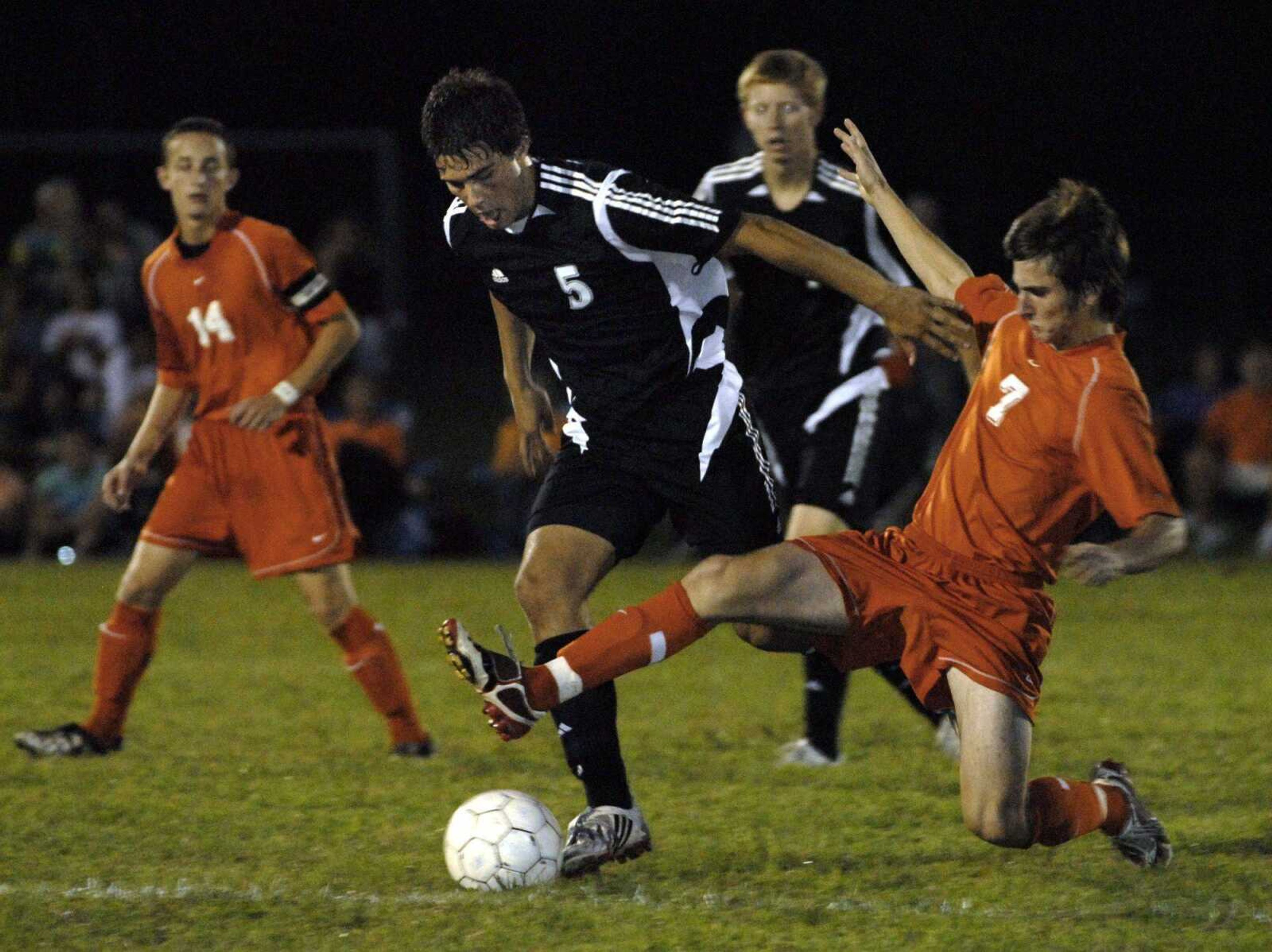 Jackson's Clayton Baker dribbles away from Central's Michael Denmark during the first half Tuesday at Central. (Fred Lynch)