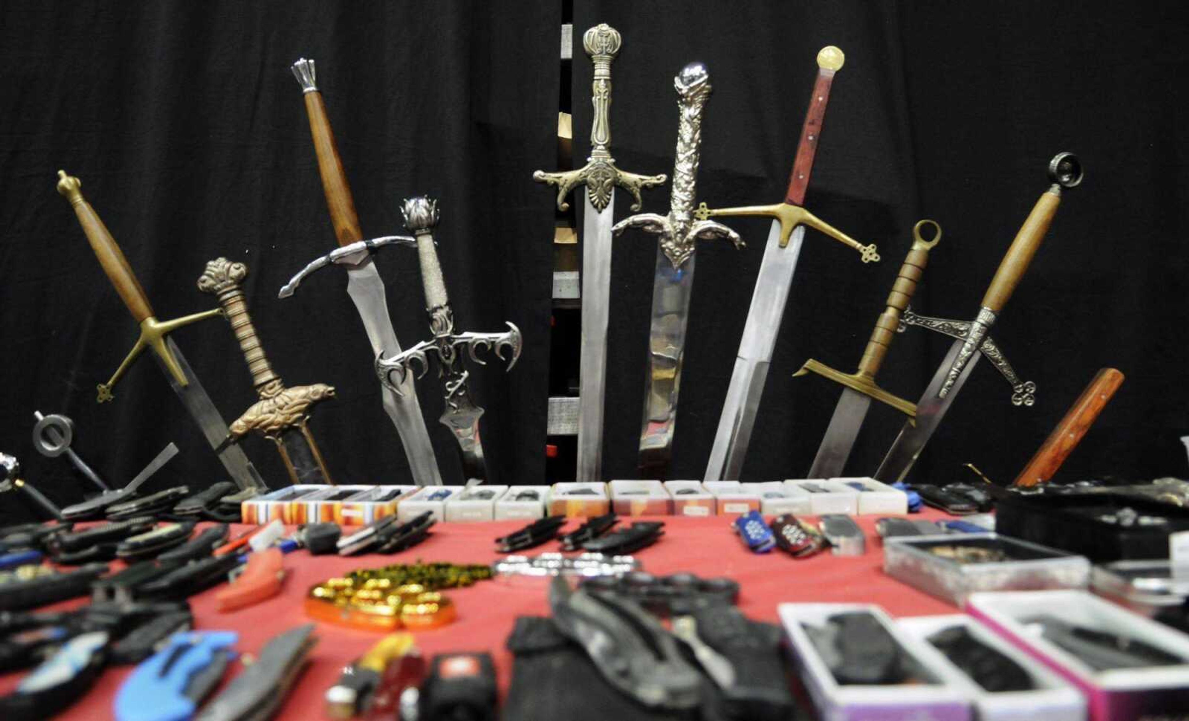 An assortment of swords and knives are displayed at a booth operated by Tom and Ronda Skelton of Mom and Pops Discount Variety Store during the Missouri Gun and Knife Show at the Show Me Center on Saturday, March 13, 2010. (KRISTIN EBERTS)