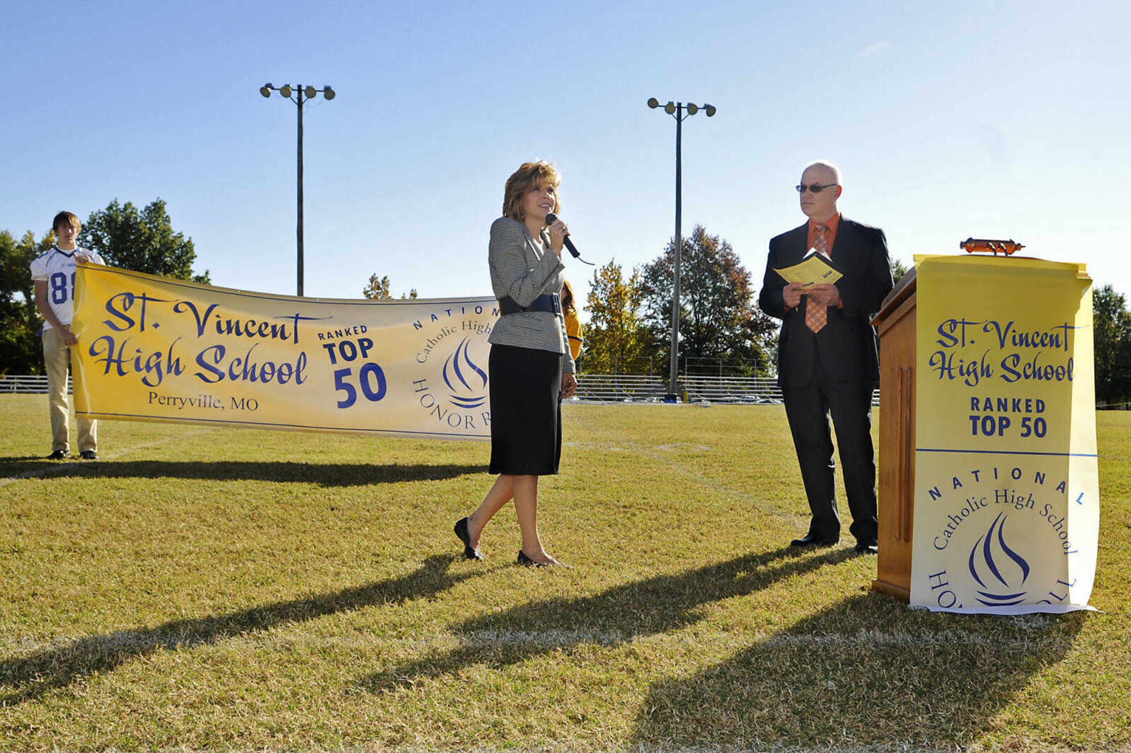 KRISTIN EBERTS ~ keberts@semissourian.com

St. Vincent High School principal Lisa Best and St. Vincent Alumni President Steve Rozier speak and students Mark Kutz and Katie Franklin hold a banner during an assembly at St. Vincent De Paul parish in Perryville, Mo., on Friday, Oct. 15, 2010, to celebrate the school's recognition on the list of the best 50 Catholic secondary schools in America, presented by the Catholic High School Honor Roll. This is the first time St. Vincent has received this distinction.