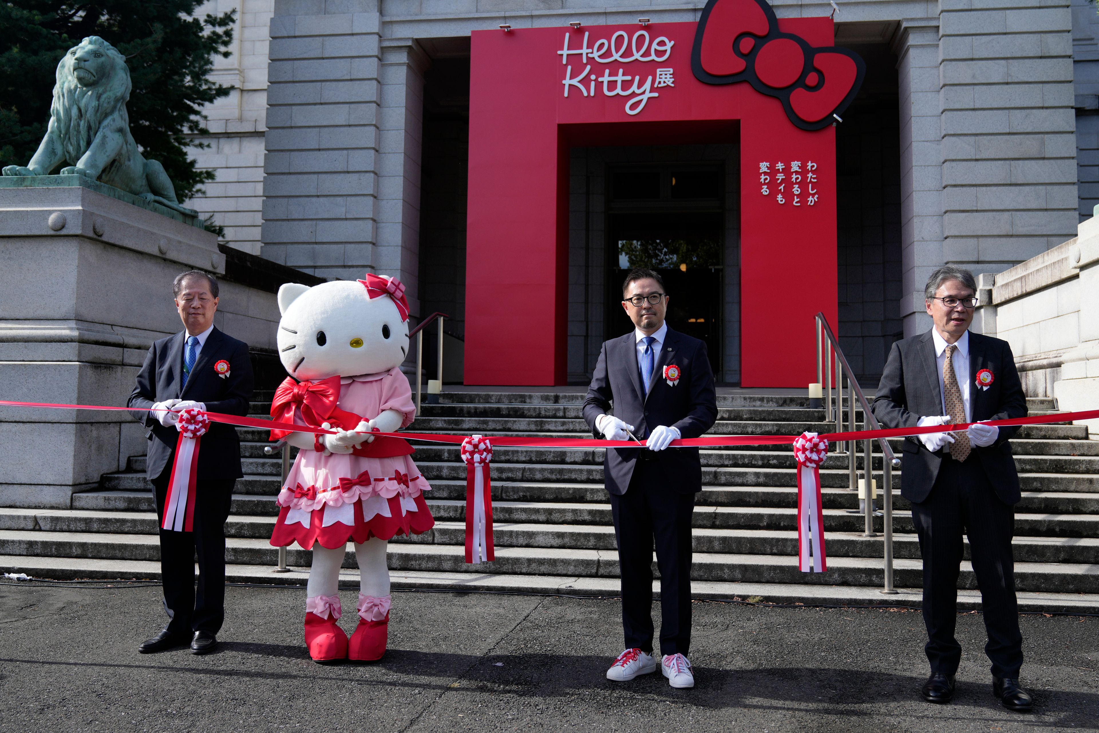 Hello Kitty, second from left, with Makoto Fujiwara, executive director of the Tokyo National Museum, left, Sanrio Senior Managing Director, Yasuyuki Otsuka, second right, and Keiichi Sawa, right, managing director of Nippon TV, attends the opening ceremony of the exhibition "As I change, so does she," marking the 50th anniversary of Hello Kitty at the Tokyo National Museum in Tokyo Wednesday, Oct. 30, 2024. (AP Photo/Shuji Kajiyama)