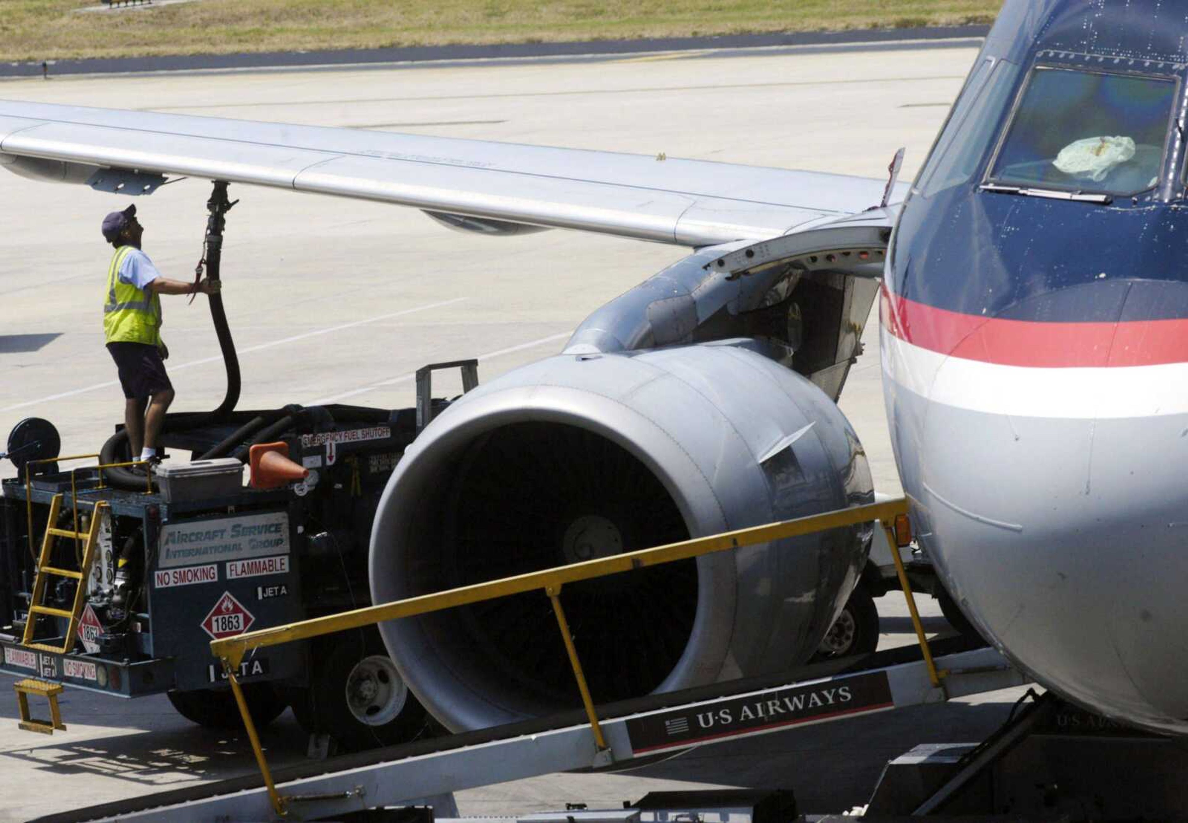 A worker hooks up a fuel hose to an airplane at Tampa International Airport on June 12, 2008, in Tampa, Fla. Airline executives frequently complain about fuel costs. (Brian McDermott ~ Associated Press file)