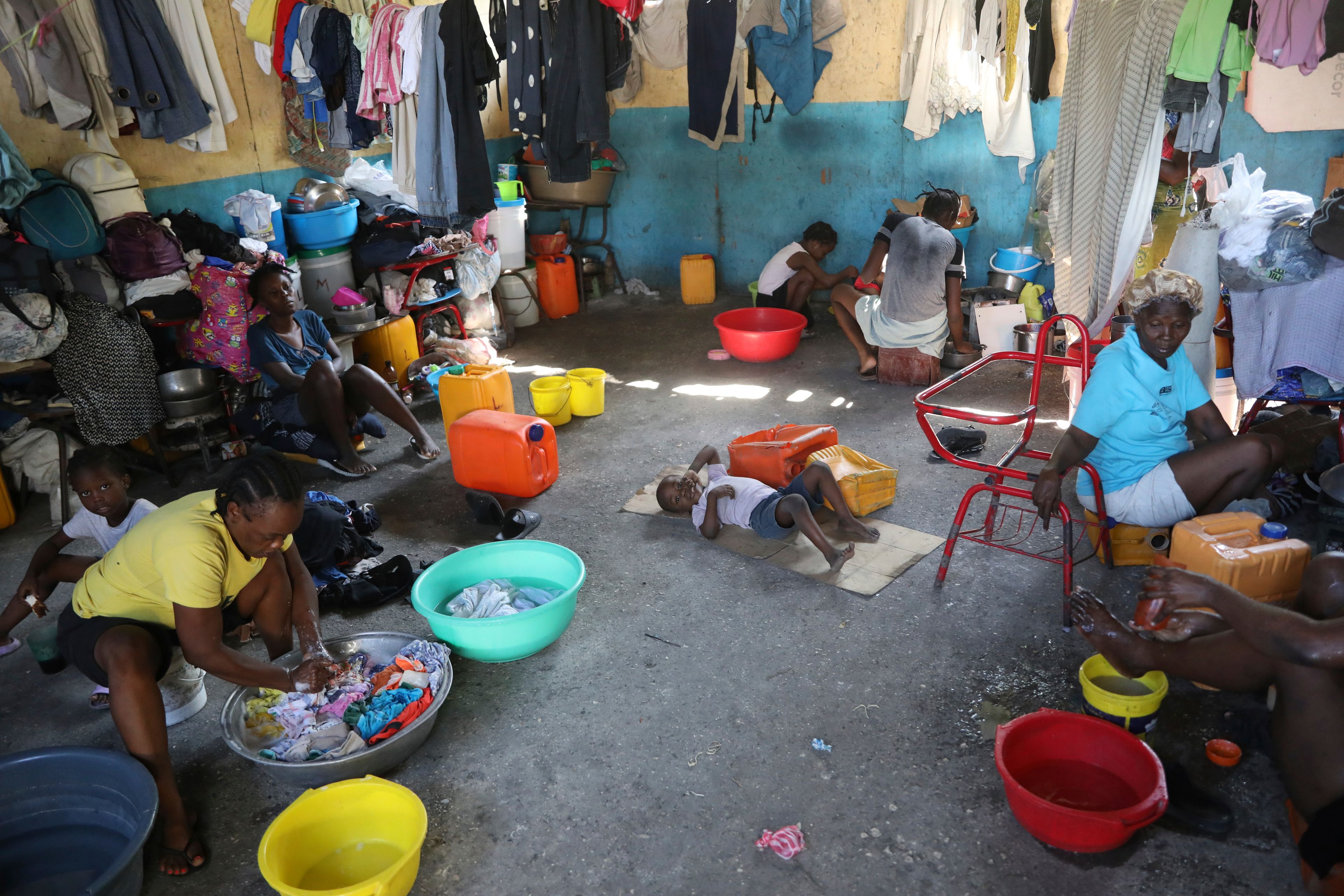 Families displaced by gang violence do laundry inside a school where they have been taking refuge for over a year in Port-au-Prince, Haiti, Friday, Sept. 20, 2024. (AP Photo/Odelyn Joseph)