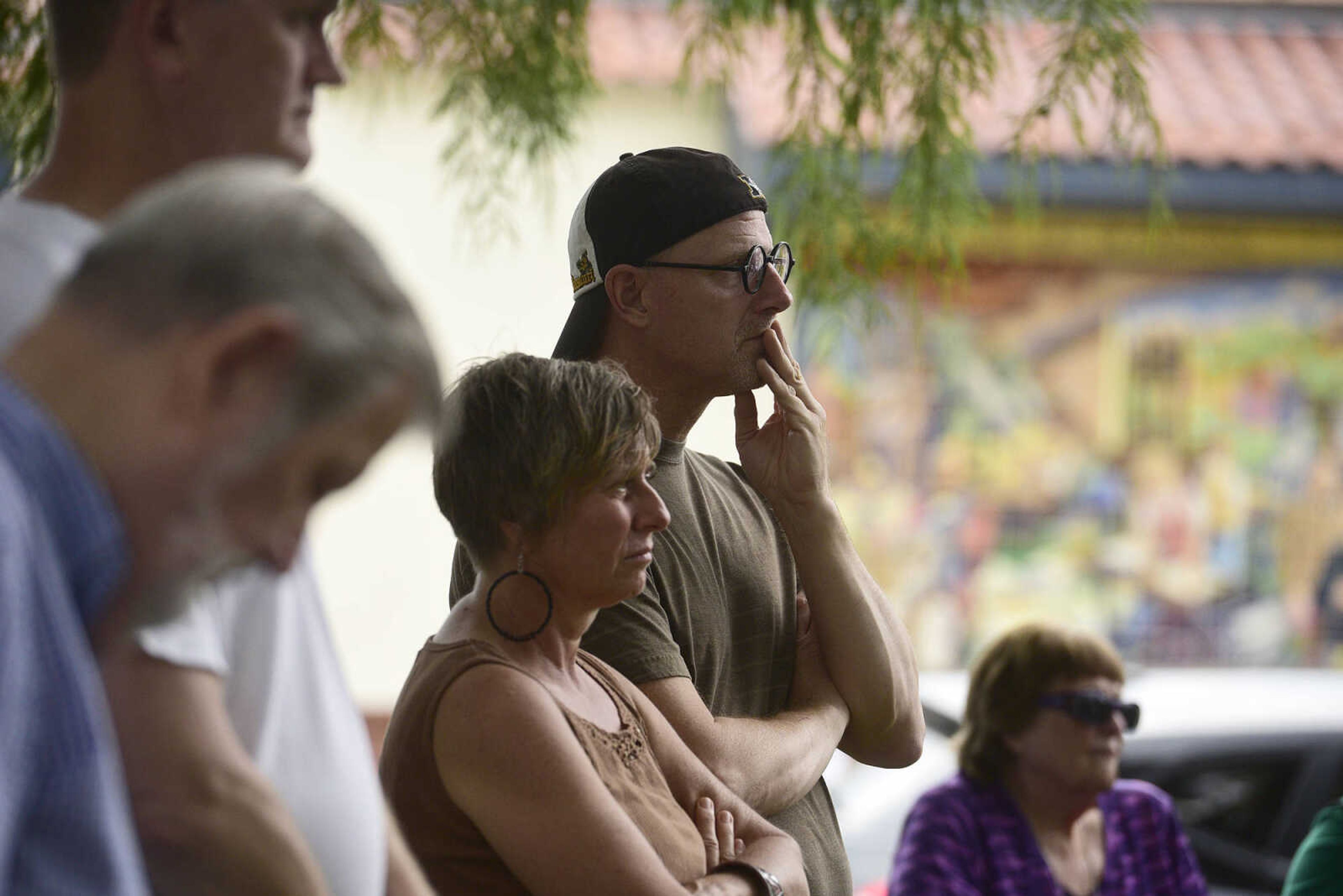 Liz Tullai and Tim Weber listen to a speaker during the Love, Not Hate rally on Sunday evening, Aug. 13, 2017, at Ivers Square in Cape Girardeau.