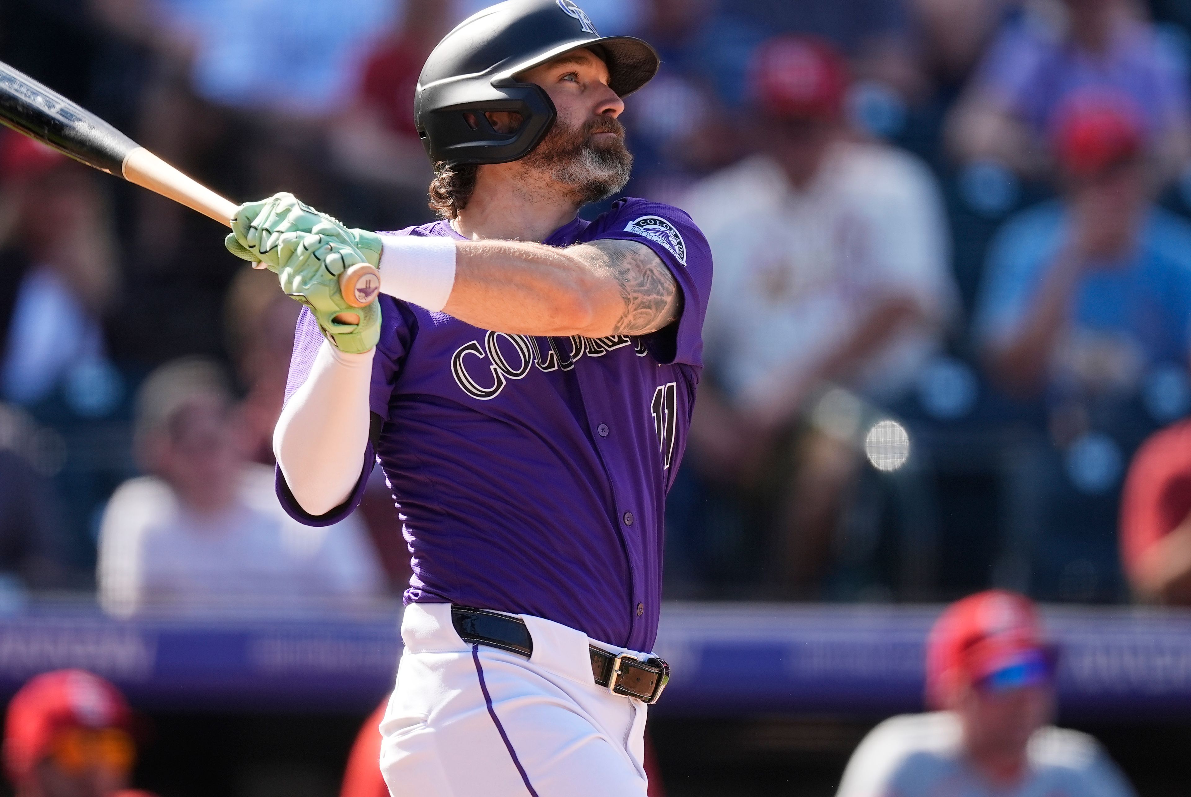 Colorado Rockies' Jake Cave follows the flight of his double off St. Louis Cardinals starting pitcher Kyle Gibson in the fourth inning of a baseball game Thursday, Sept. 26, 2024, in Denver. (AP Photo/David Zalubowski)