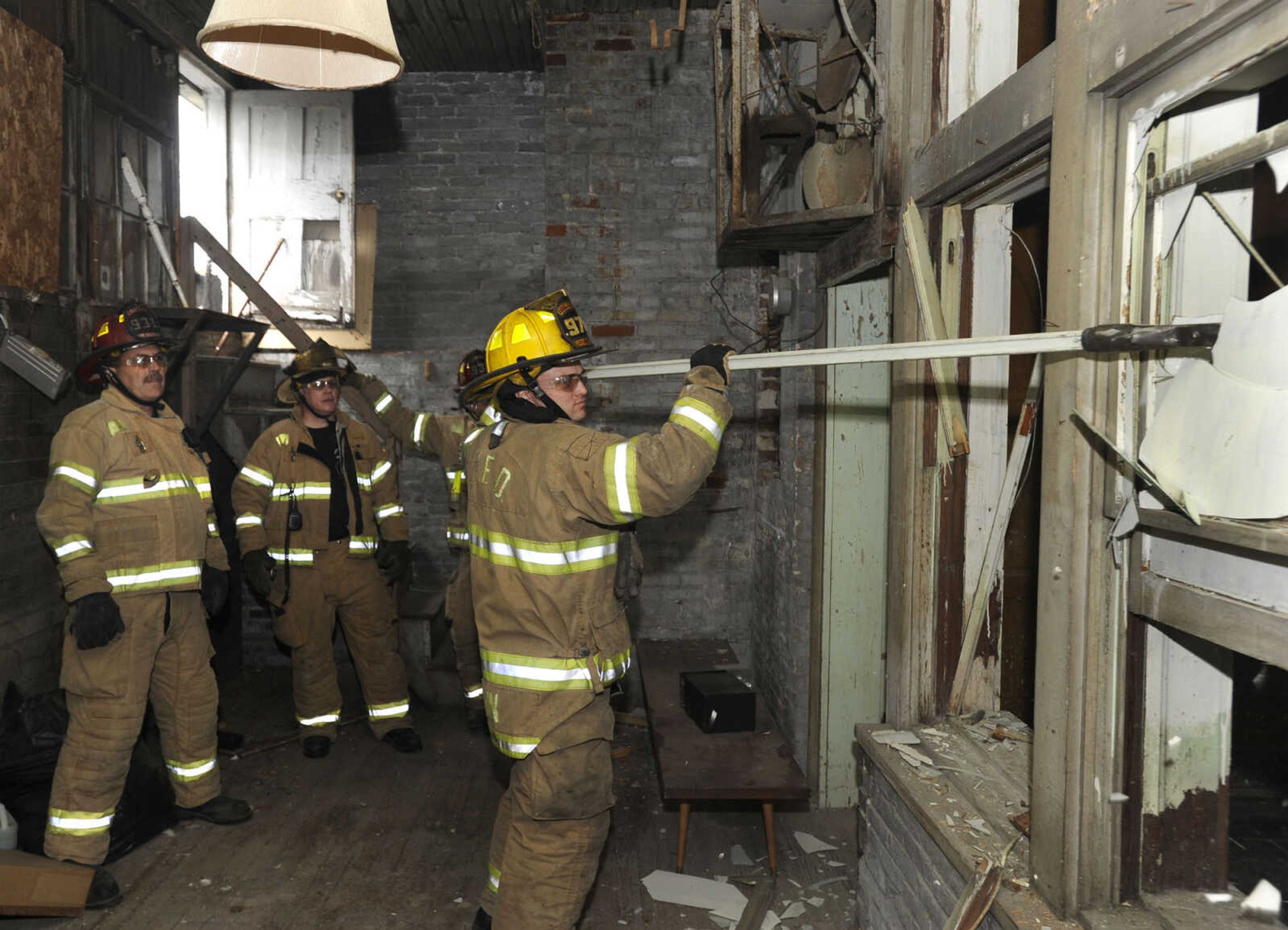 Firefighter Jamie Hann takes a turn at window breaking during the training session.