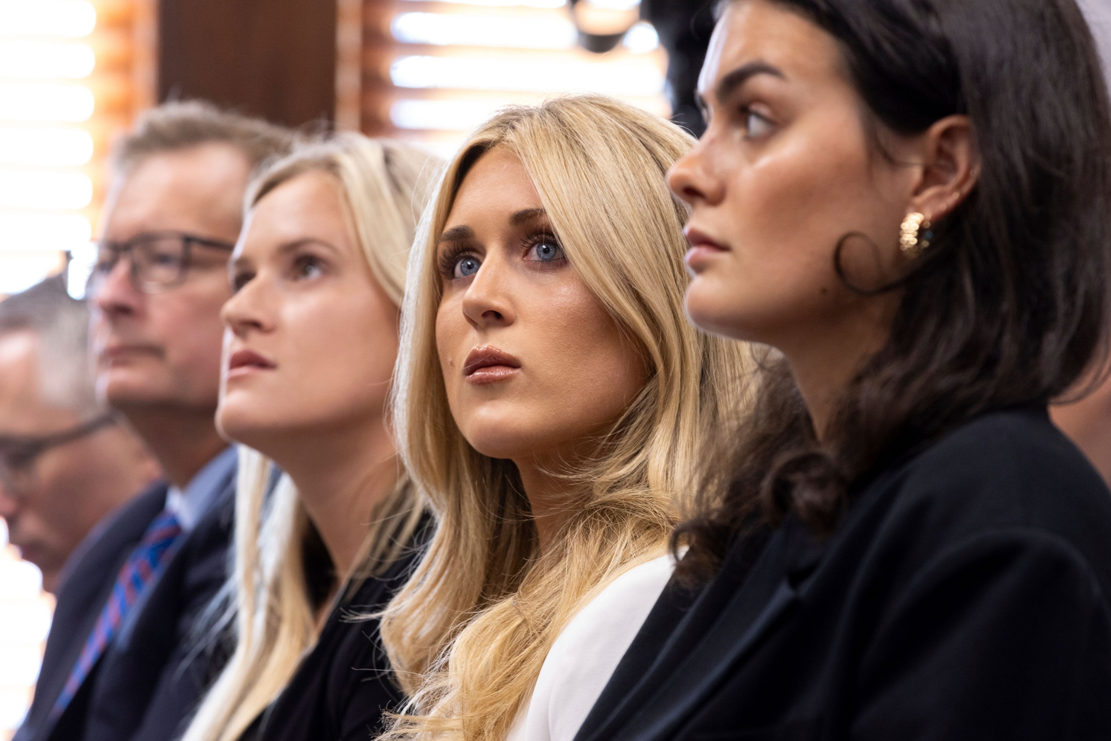 FILE - From third left, former collegiate swimmers Kaitlynn Wheeler, Riley Gaines, and Grace Countie prepare to testify in opposition to transgender athletes in women's sports in front of the state senate's Special Committee on Protecting Women's Sports at the Capitol in Atlanta, Tuesday, Aug. 27, 2024. (Arvin Temkar/Atlanta Journal-Constitution via AP, File)