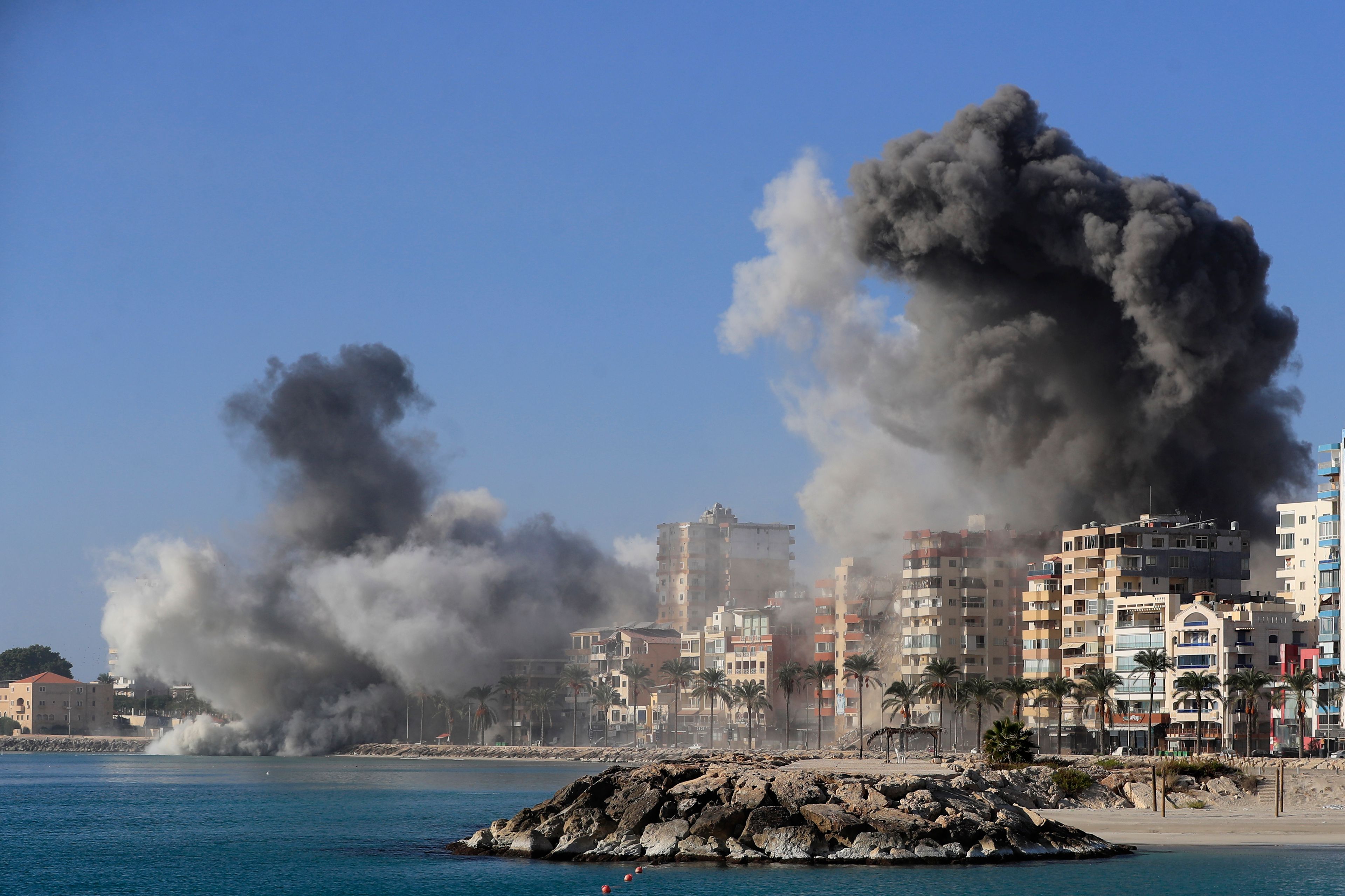 Smoke rises from buildings hit in Israeli airstrikes in Tyre, southern Lebanon, Monday, Oct. 28, 2024. (AP Photo/Mohammad Zaatari)