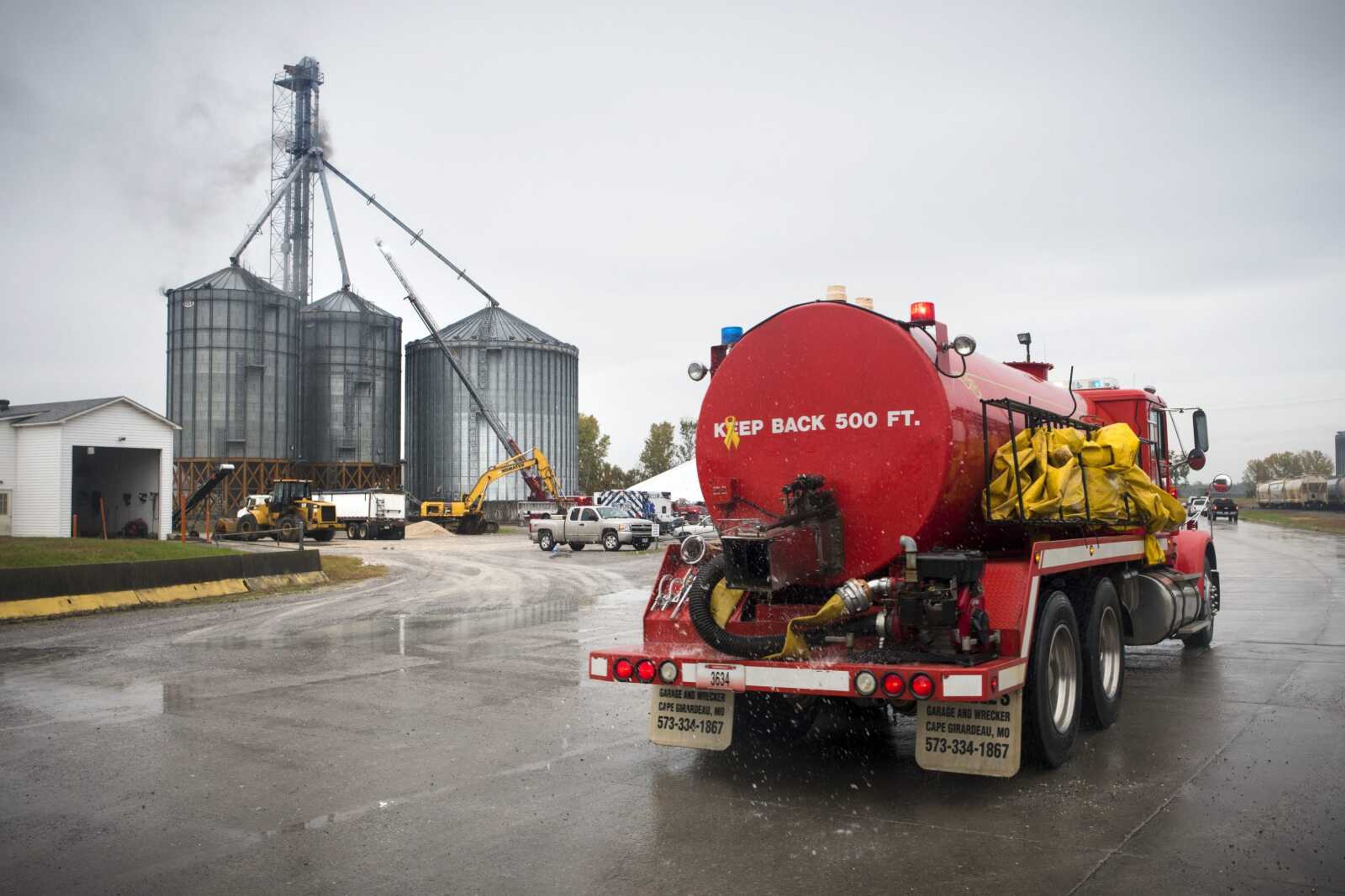 A tanker unit from Gordonville arrives at the scene of a two-alarm fire Wednesday behind a group of grain silos at Midwest Grain and Barge in Scott City as crews from multiple departments maintain defensive positions. No one was injured in the fire, according to Scott City fire chief Trent August, but the blaze destroyed soybean products and caused damage to metal structures in and around the silo.