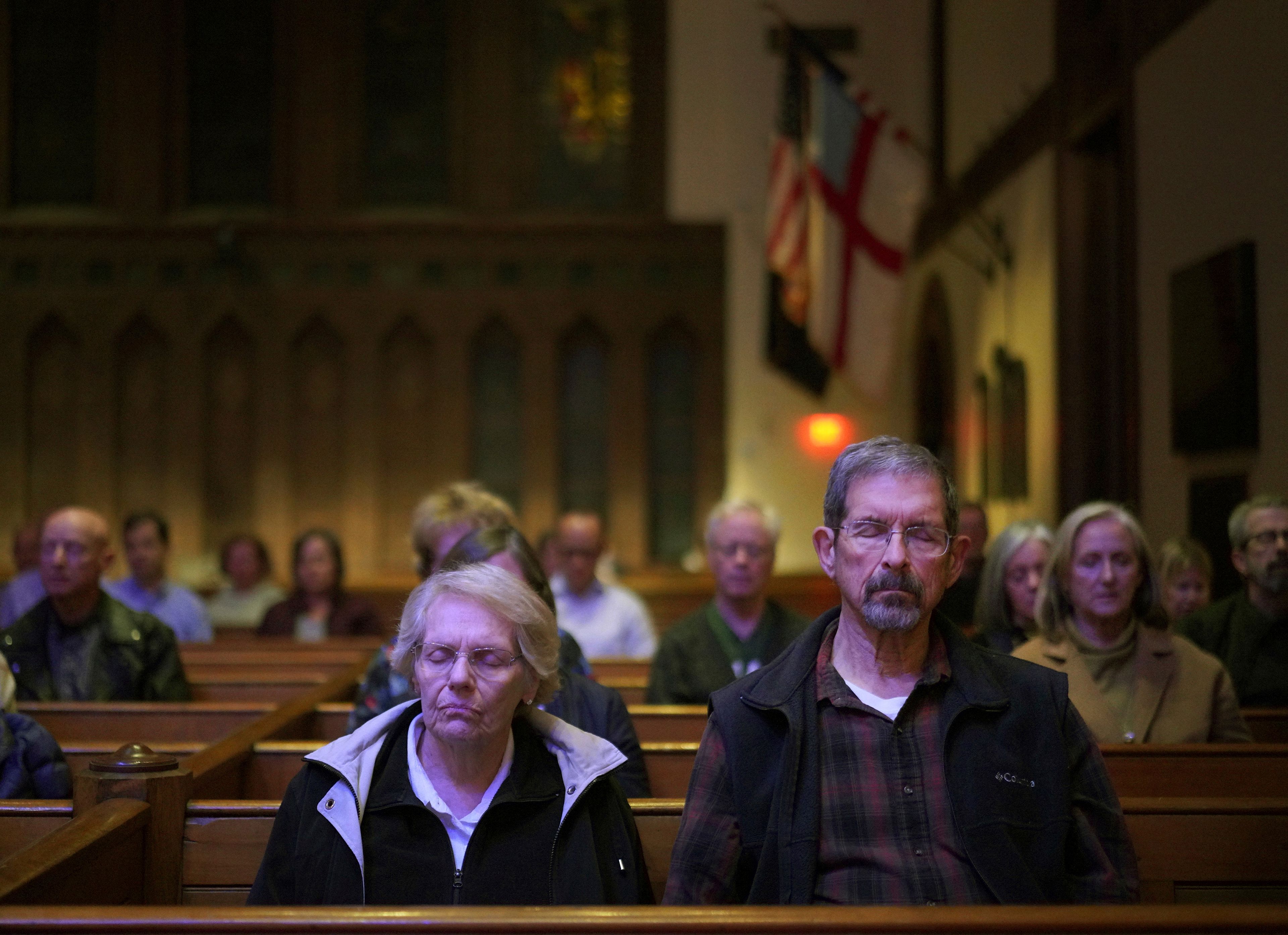 Pat, left, and Joe Weaver sit in meditation during a weekly "Contemplative Citizenship" service at St. James Episcopal Church in Lancaster, Pa., on Tuesday, Oct. 15, 2024. (AP Photo/Jessie Wardarski)