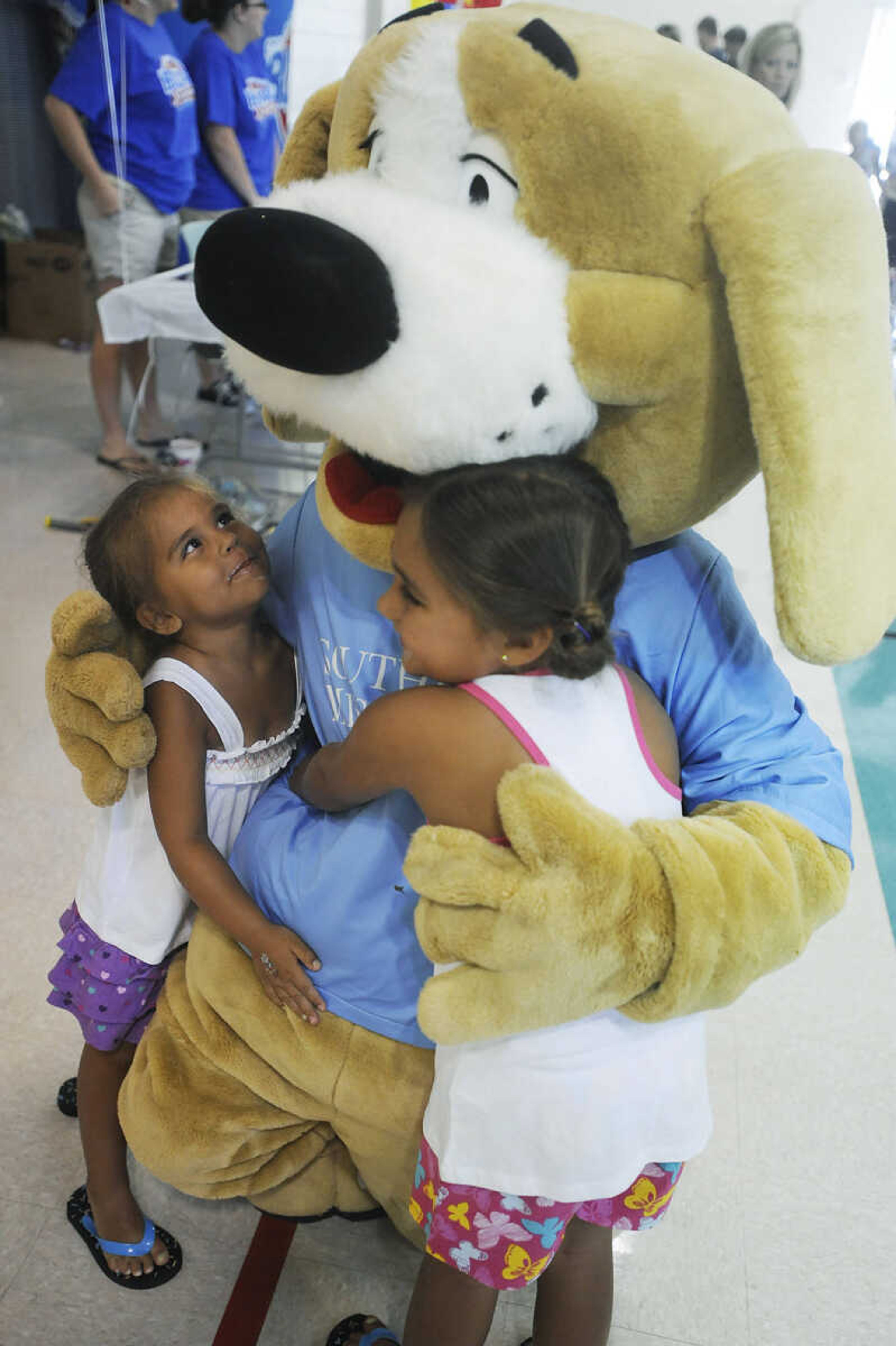 ADAM VOGLER ~ avogler@semissourian.com
Tracker gets a hug from Portia, 4, left, Phoenix, 6, Schmidt during the 11th annual Cape Girardeau Parks and Rec Day Friday, July 13, at the Osage Center.