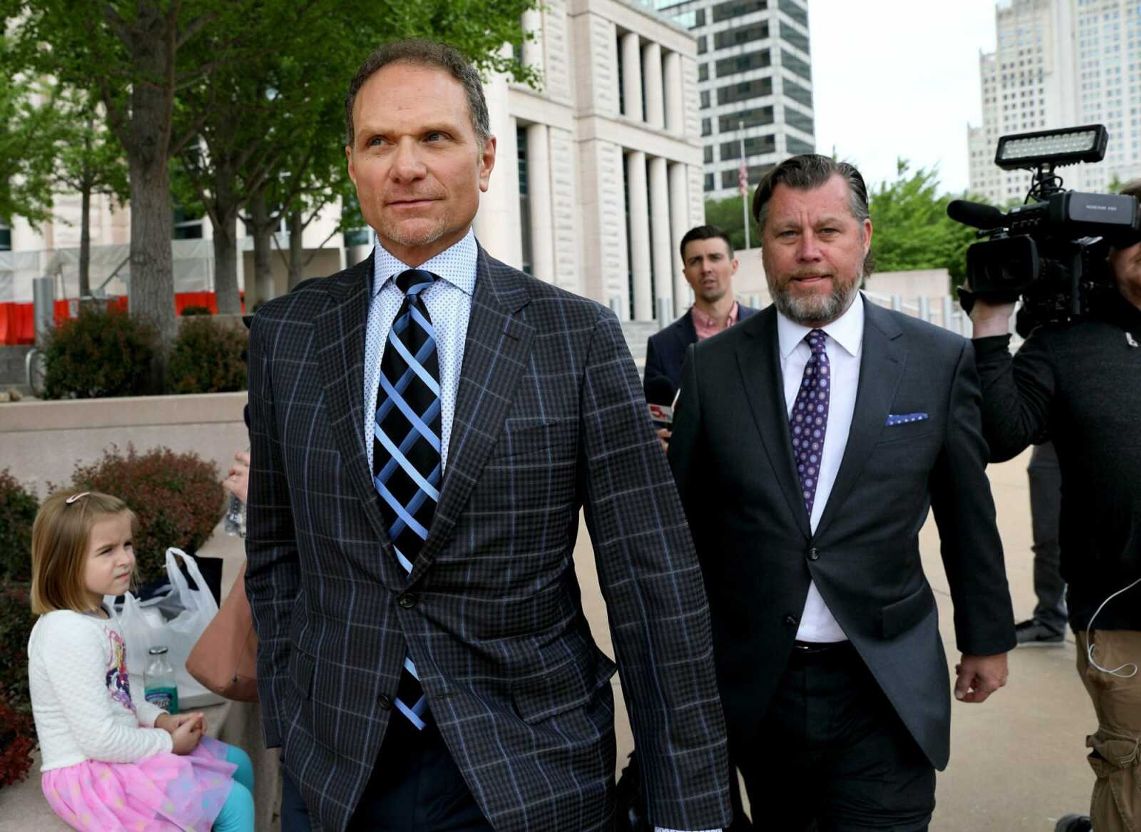 Businessman John Rallo, left, and his lawyer John Rogers leave federal court Friday in St. Louis. Rallo, accused in a pay-to-play scheme with St. Louis County's former top elected official, pleaded not guilty Friday to three federal bribery charges.