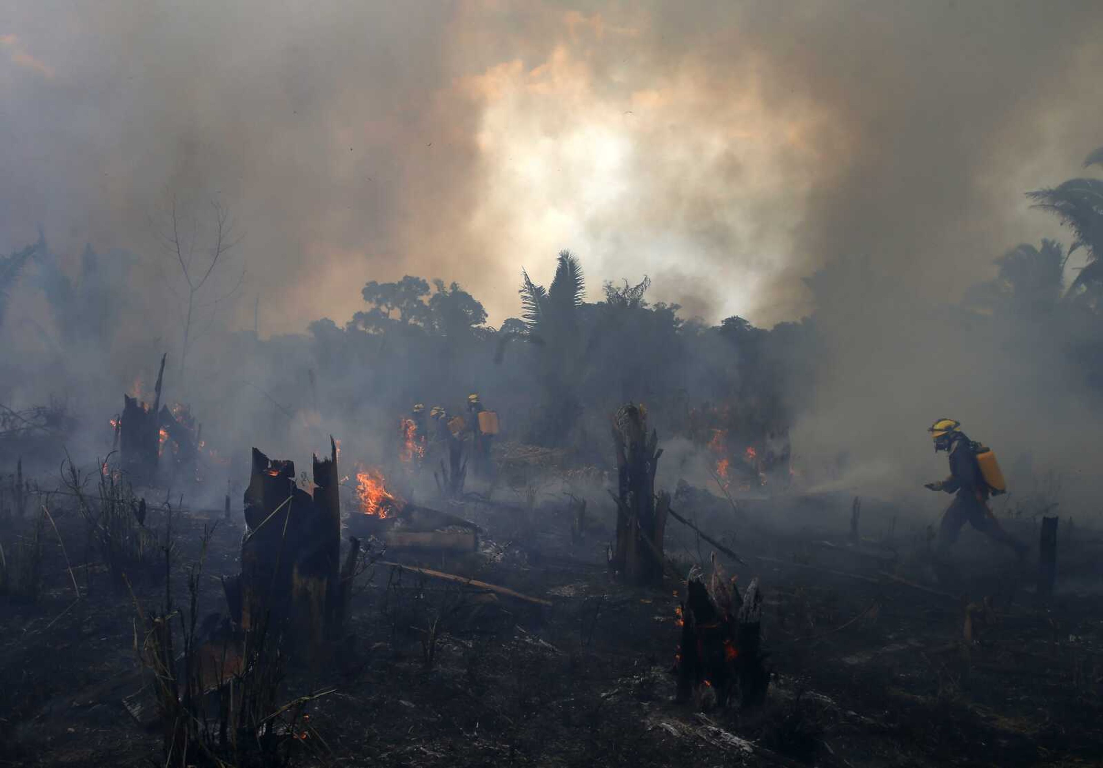 Fire brigade members work to put out fires Sept. 21 in Apui, Amazonas state, Brazil.