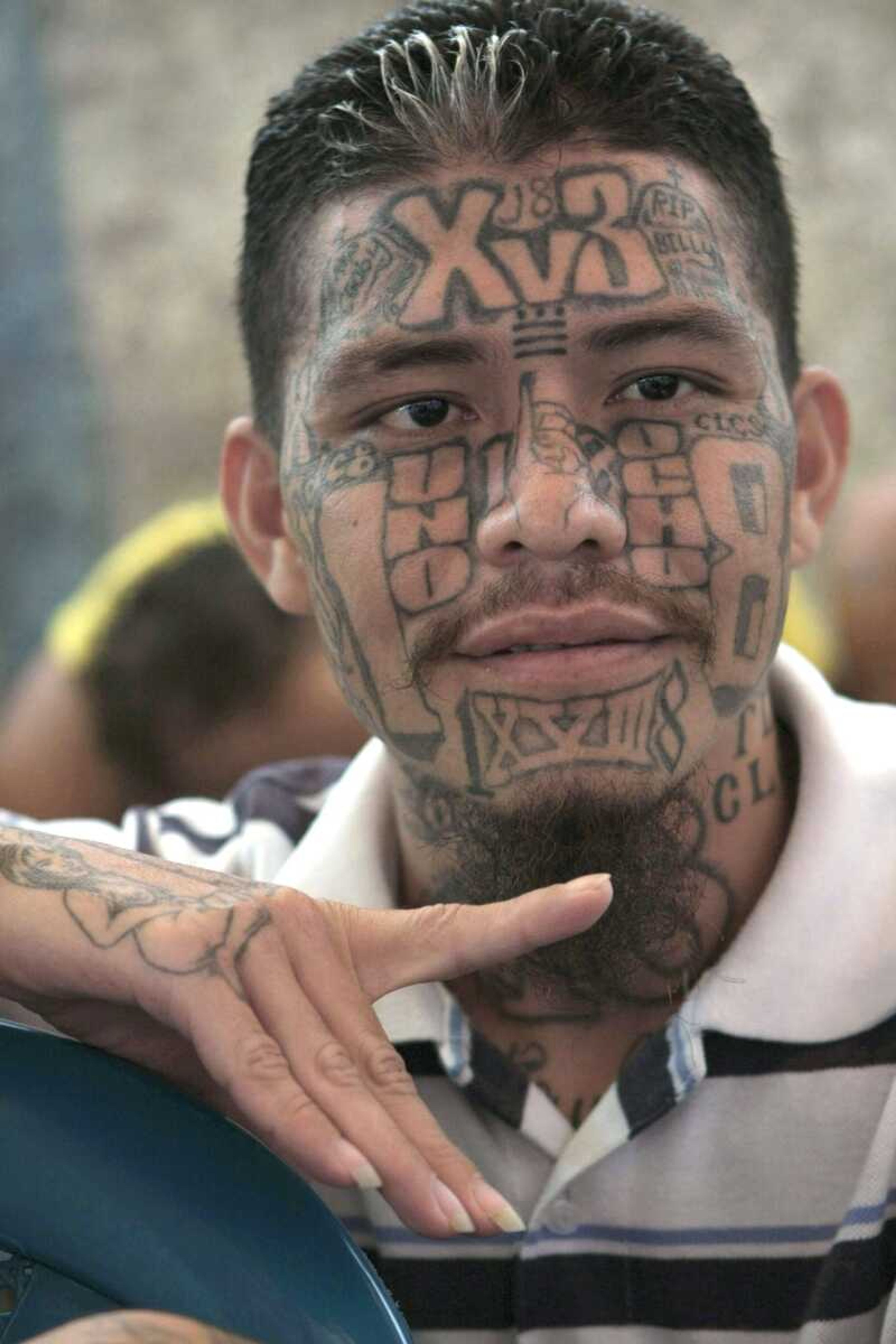 An inmate belonging to the Barrio 18 gang gestures Sept. 1 inside the prison in Cojutepeque, El Salvador. <br>Luis Romero<br>Associated Press