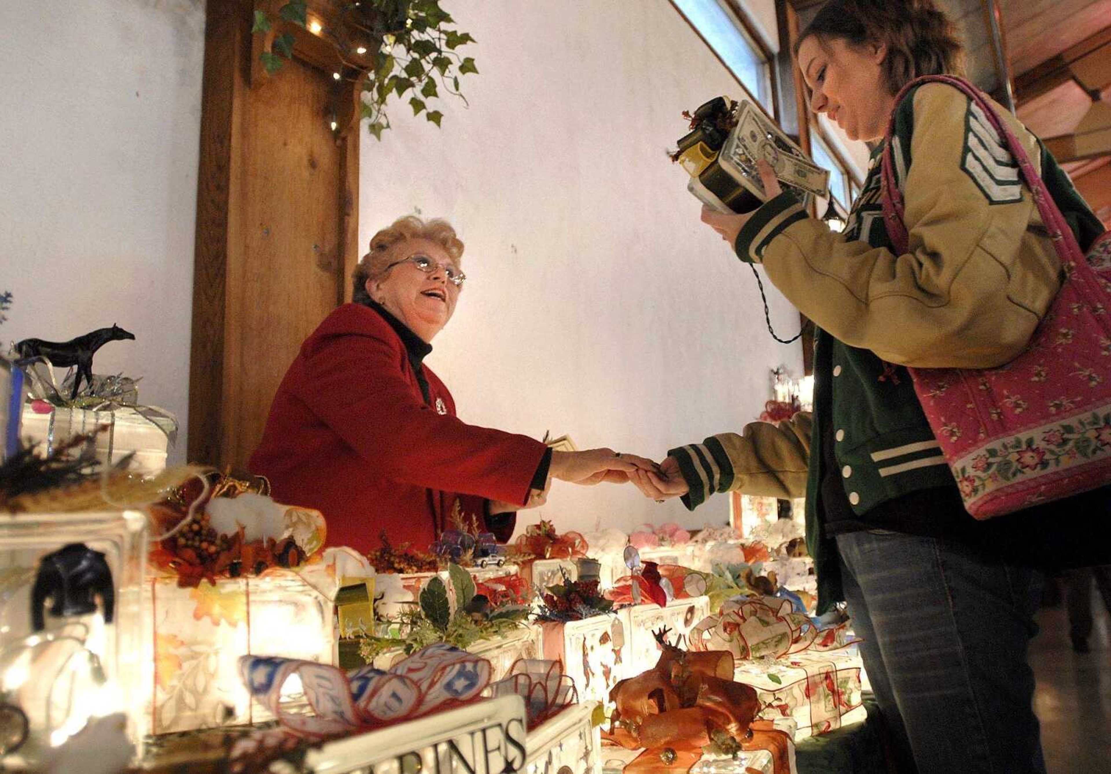 FRED LYNCH ~ flynch@semissourian.com
Carolyn Cox of Sikeston, Mo. sells a crafted nightlight to Aleshia Trovillion of Whitewater, Mo. at the Crafts, Gifts and Collectibles Show at Bavarian Halle Saturday.