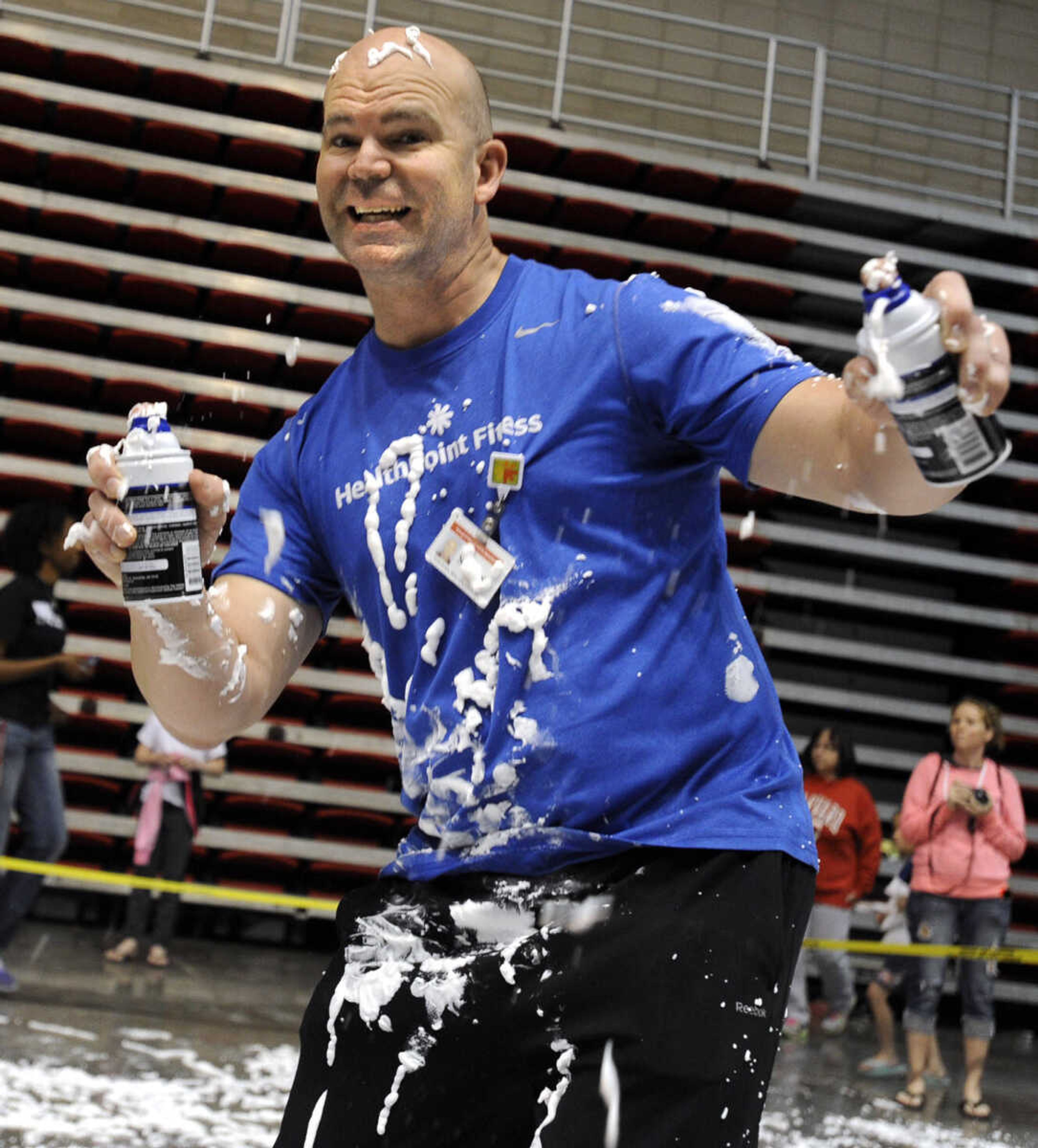 Scott Givens with HealthPoint Fitness prepares the Shaving Cream Crawl event at the Messy Morning event Saturday, April 25, 2015 at the Show Me Center.