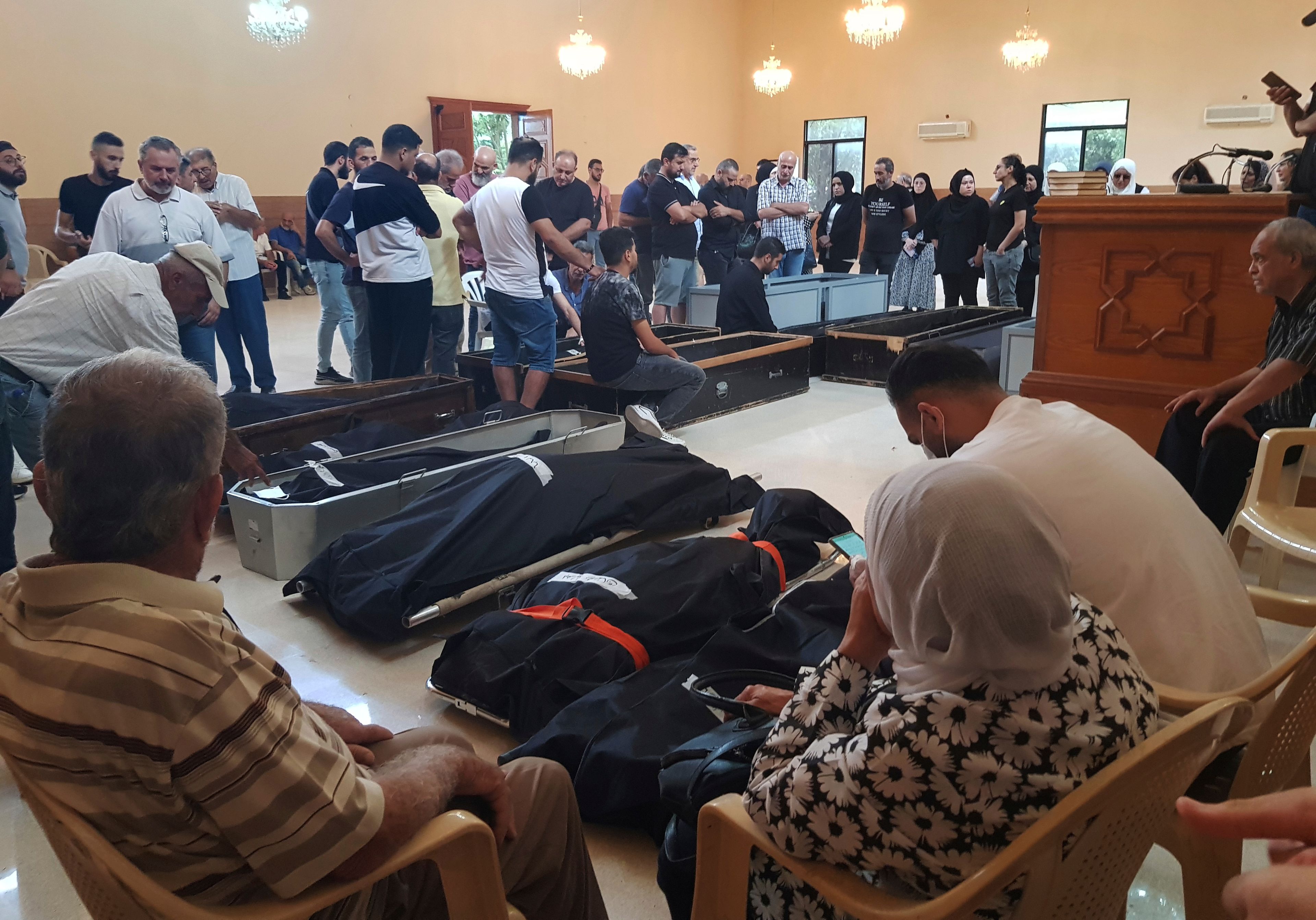 Mourners gather at a mosque next of the bodies of their relatives who were killed on Sept. 29 in Ain el Delb during the deadliest Israeli airstrike on a residential building during the first week of escalation between Israel and Hezbollah where more than 70 people were killed, in the southern port city of Sidon, Lebanon, Thursday, Oct. 10, 2024. (AP Photo/Mohammed Zaatari)