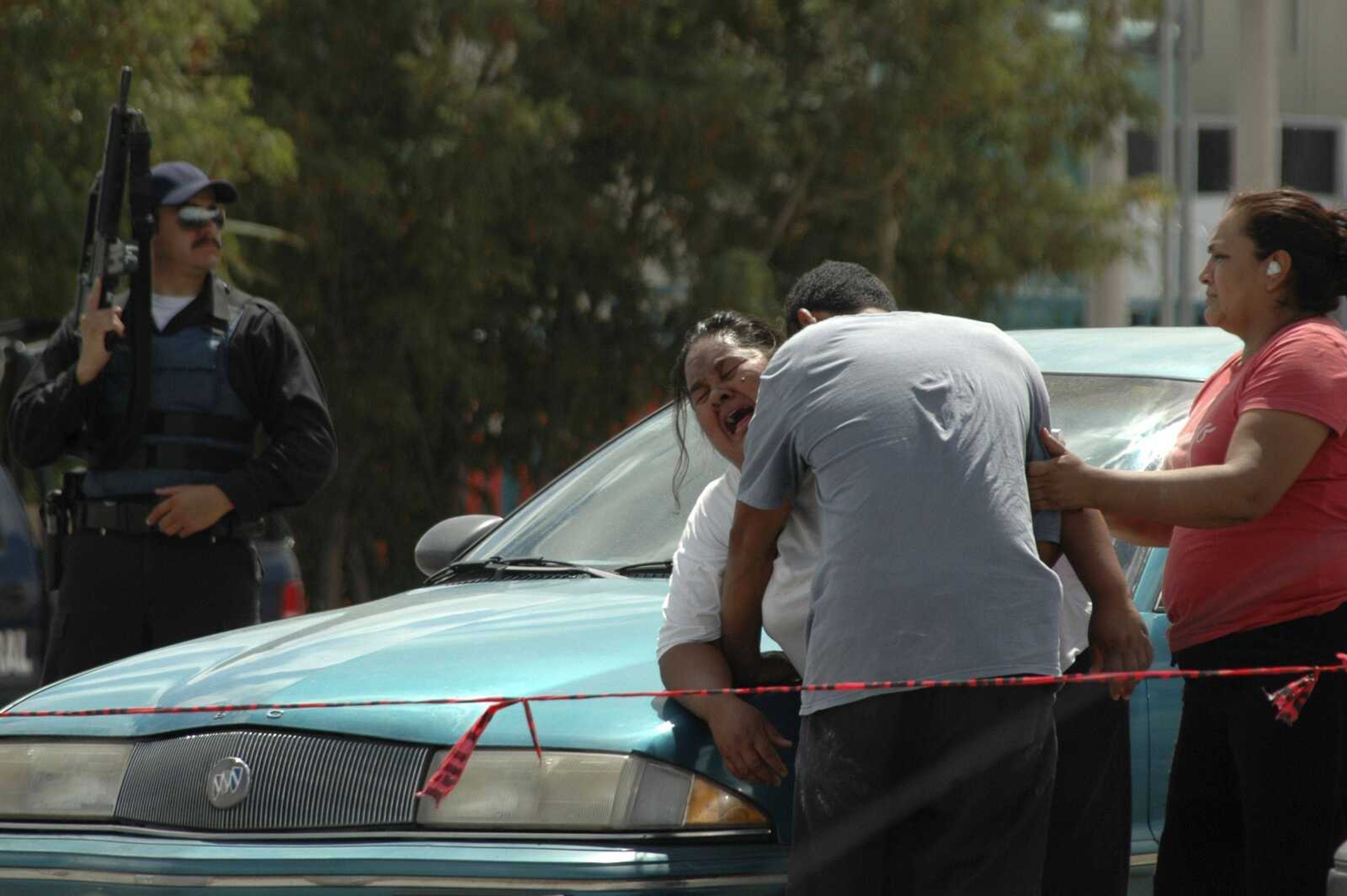 A woman cries after learning that her son was killed as she stands at the crime scene Thursday in the northern border city of Ciudad Juarez, Mexico. Ciudad Juarez has become one of Mexico's deadliest cities as drug gangs continue to battle for control of smuggling routes. (Raymundo Ruiz ~ Associated Press)