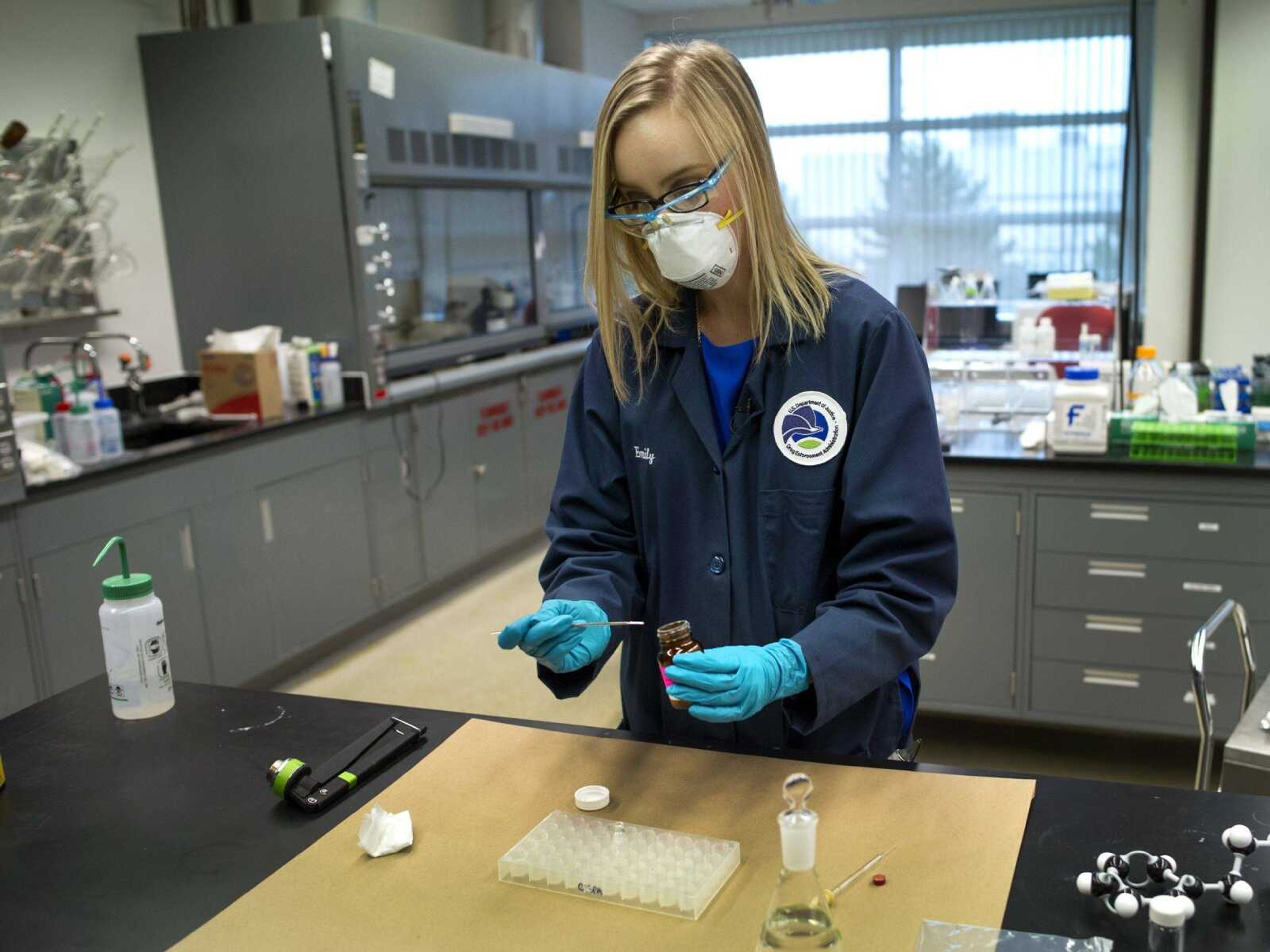 Drug Enforcement Administration forensic chemist Emily Dye prepares a control reference sample of fentanyl at the DEA's Special Testing and Research Laboratory on Aug. 9 in Sterling, Virginia. A novel class of deadly drugs is exploding across the country, with many manufactured in China for export around the world.