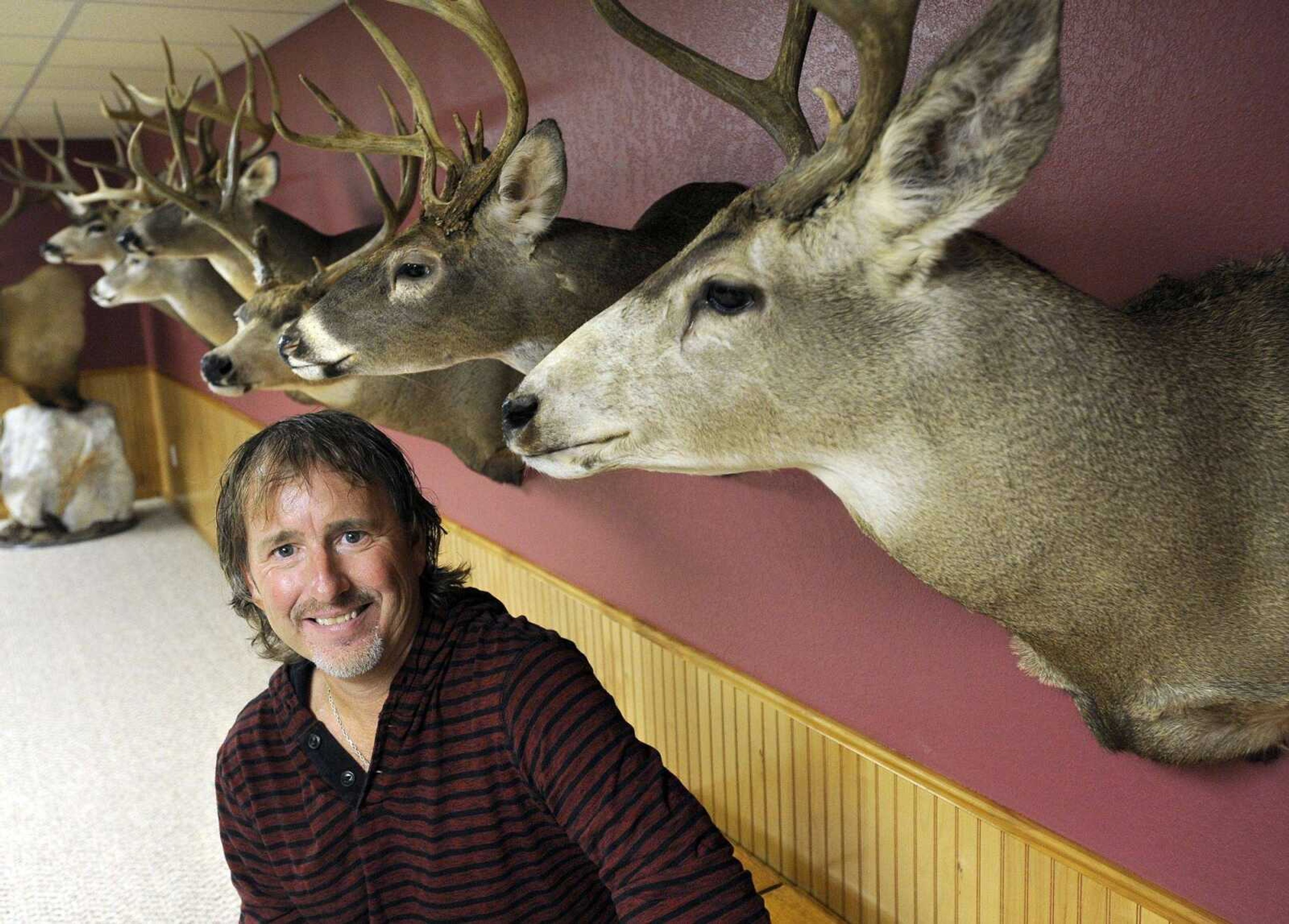 A wall of deer trophies remind Jeff Bollinger of memorable hunting experiences.