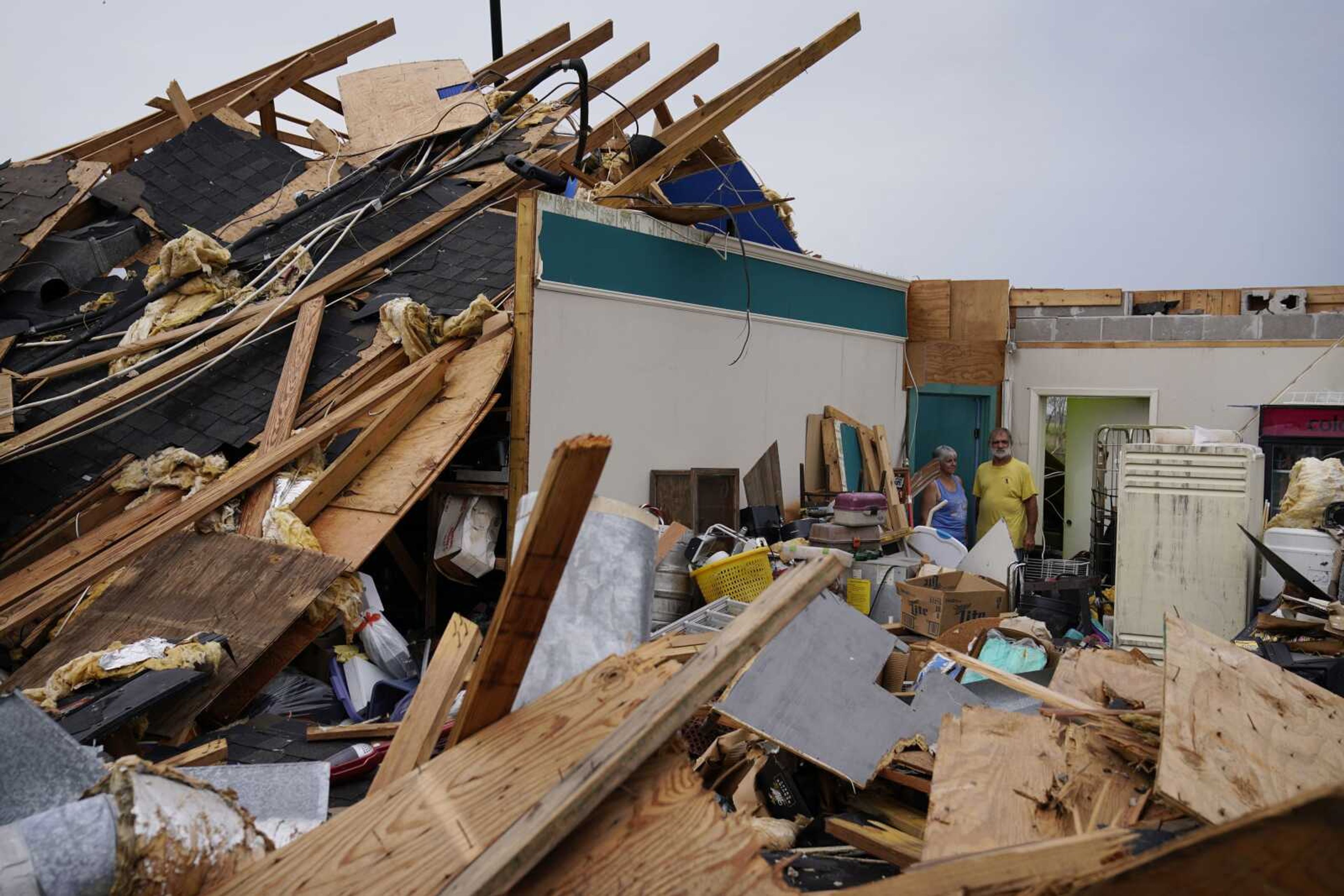 Guthrie Matherne, left, and Blakland Matherne, right, looks at what remains of their hurricane-destroyed business in the aftermath of Hurricane Ida on Monday in Lockport, Louisiana.