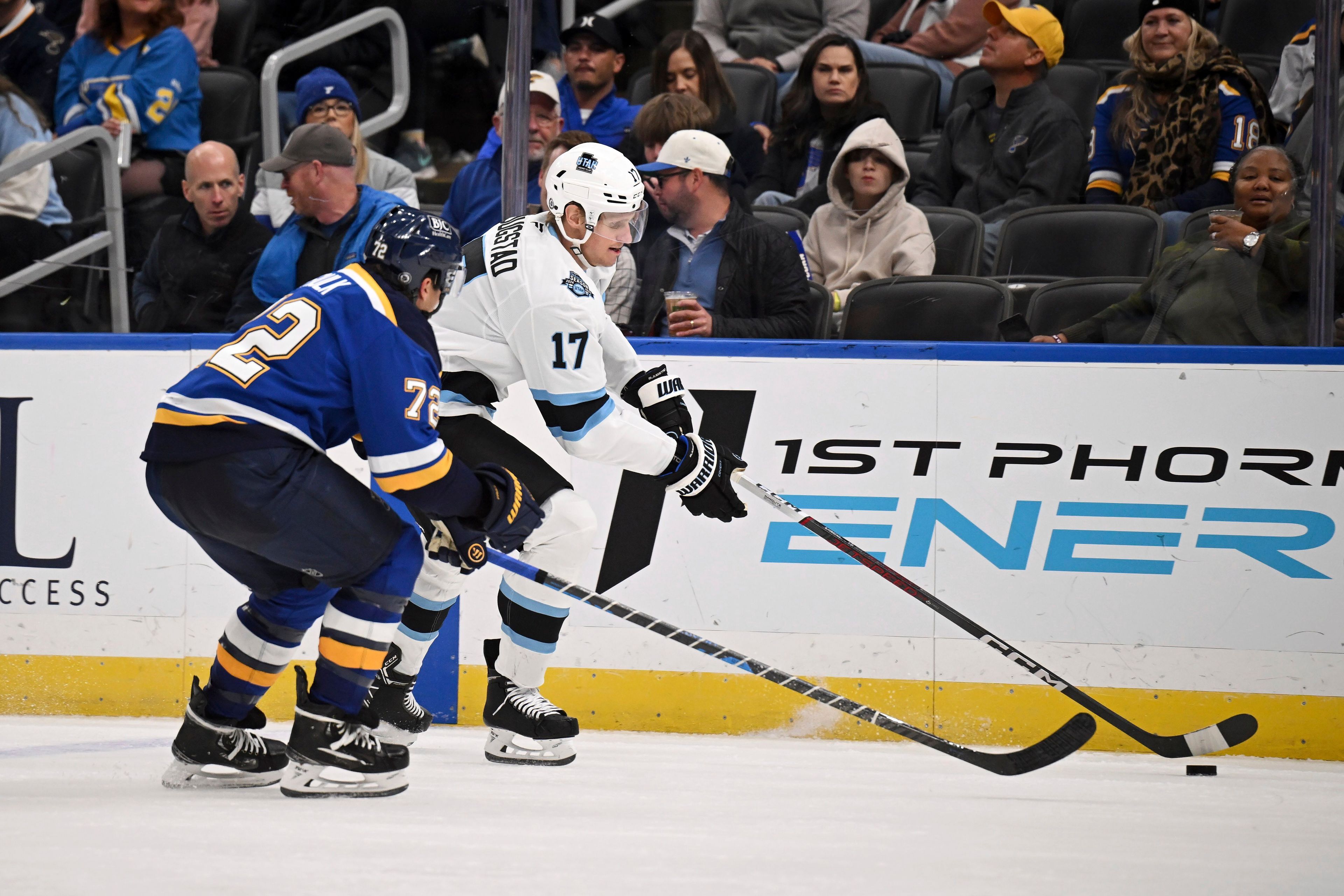 St. Louis Blues' Justin Faulk (72), left, pressures Utah Hockey Club's Nick Bjugstad (17) while he controls the puck during the third period of an NHL hockey game Thursday, Nov. 7, 2024, in St. Louis. (AP Photo/Connor Hamilton)