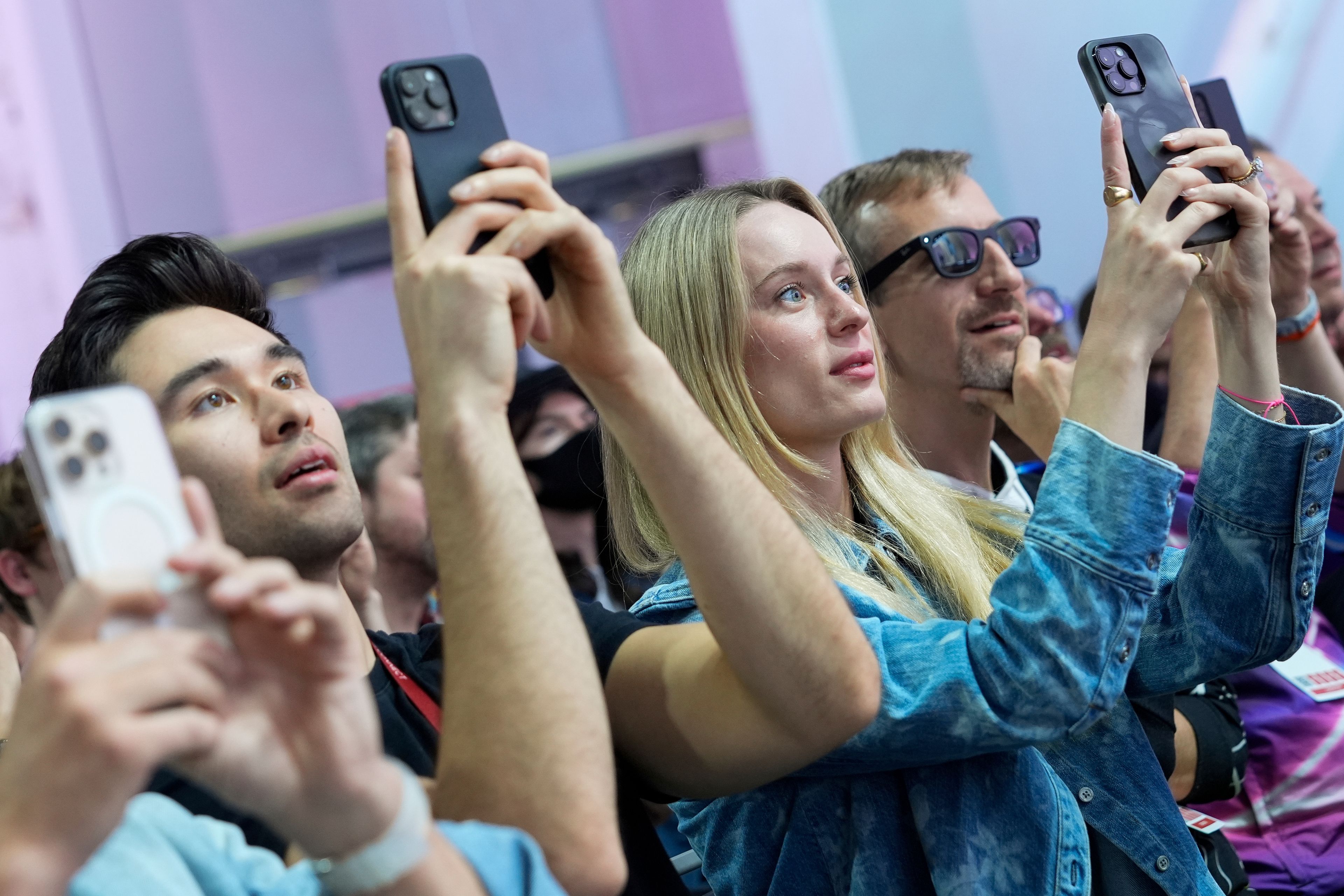 People use their cell phones as they watch a presentation at the Meta Connect conference Wednesday, Sept. 25, 2024, in Menlo Park, Calif. (AP Photo/Godofredo A. Vásquez)