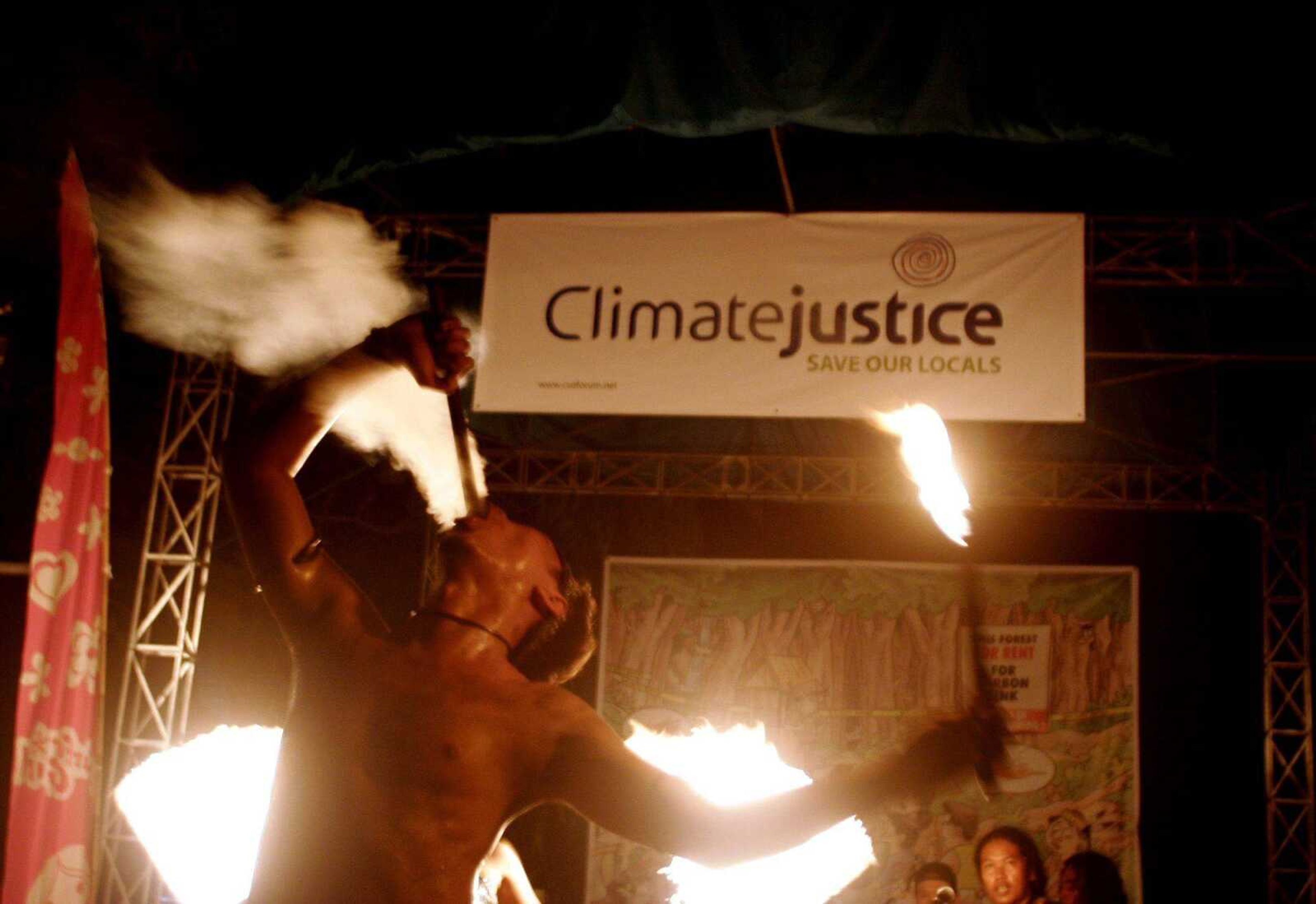 An Indonesian man ate fire Thursday during a festival put on by nongovernment environmental organizations on the sidelines of the U.N. Climate Change Conference in Nusa Dua, Bali, Indonesia. (Binsar Bakkara ~ Associated Press)