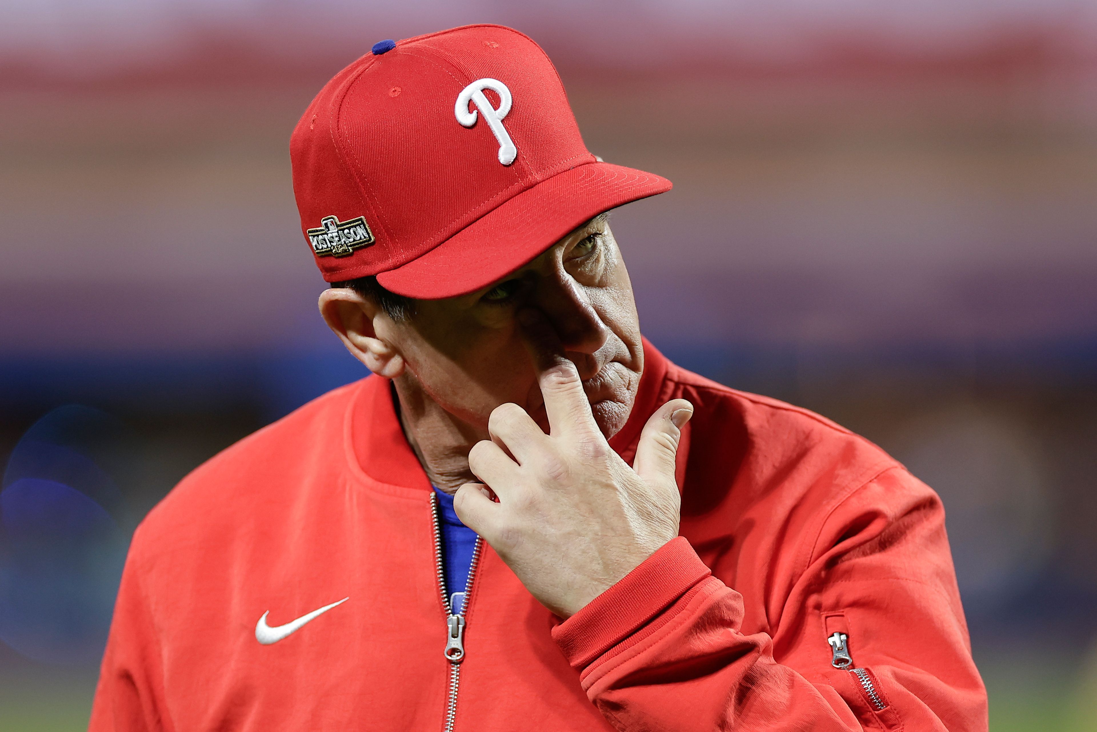 Philadelphia Phillies manager Rob Thomson walks off the field after a pitching change during the sixth inning of Game 4 of the National League baseball playoff series against the New York Mets, Wednesday, Oct. 9, 2024, in New York. (AP Photo/Adam Hunger)