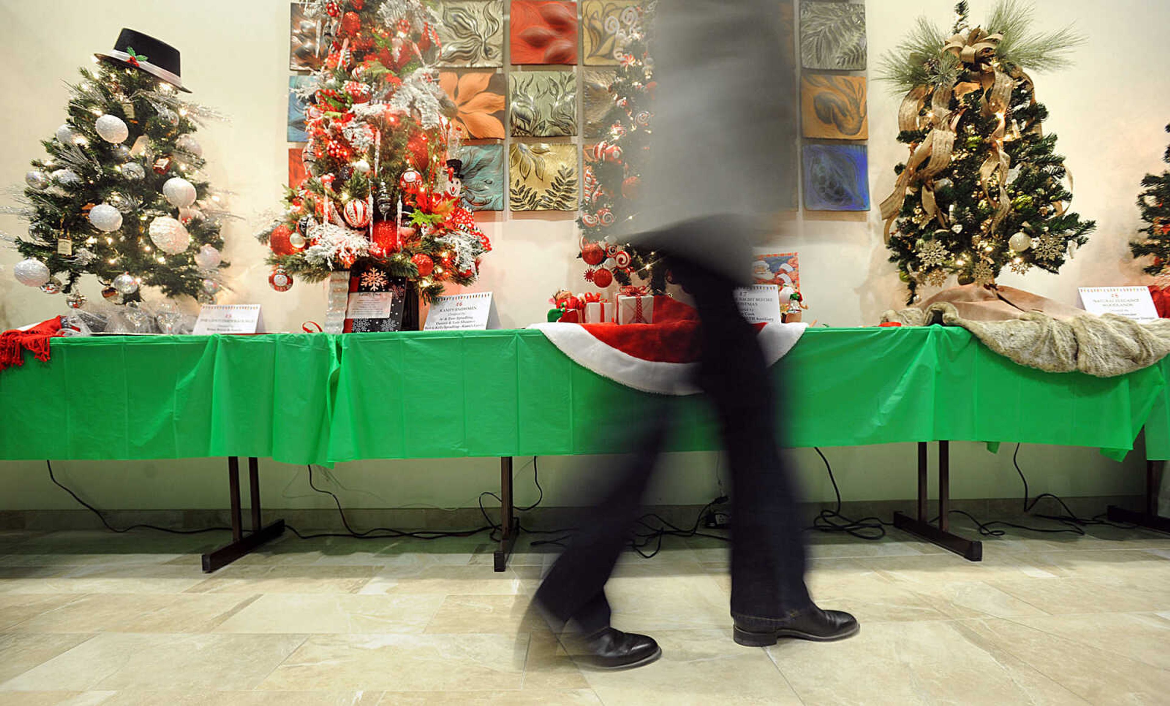 LAURA SIMON ~ lsimon@semissourian.com

People browse through the selection of holiday trees up for bid at the silent auction, Saturday, Nov. 15, 2014, during the Festival of Trees sponsored by the SoutheastHEALTH Auxiliary at Southeast Cancer Center in Cape Girardeau. The event is a fundraiser for the expansion and redesign of the Level III Neonatal Care Unit at Southeast Hospital.