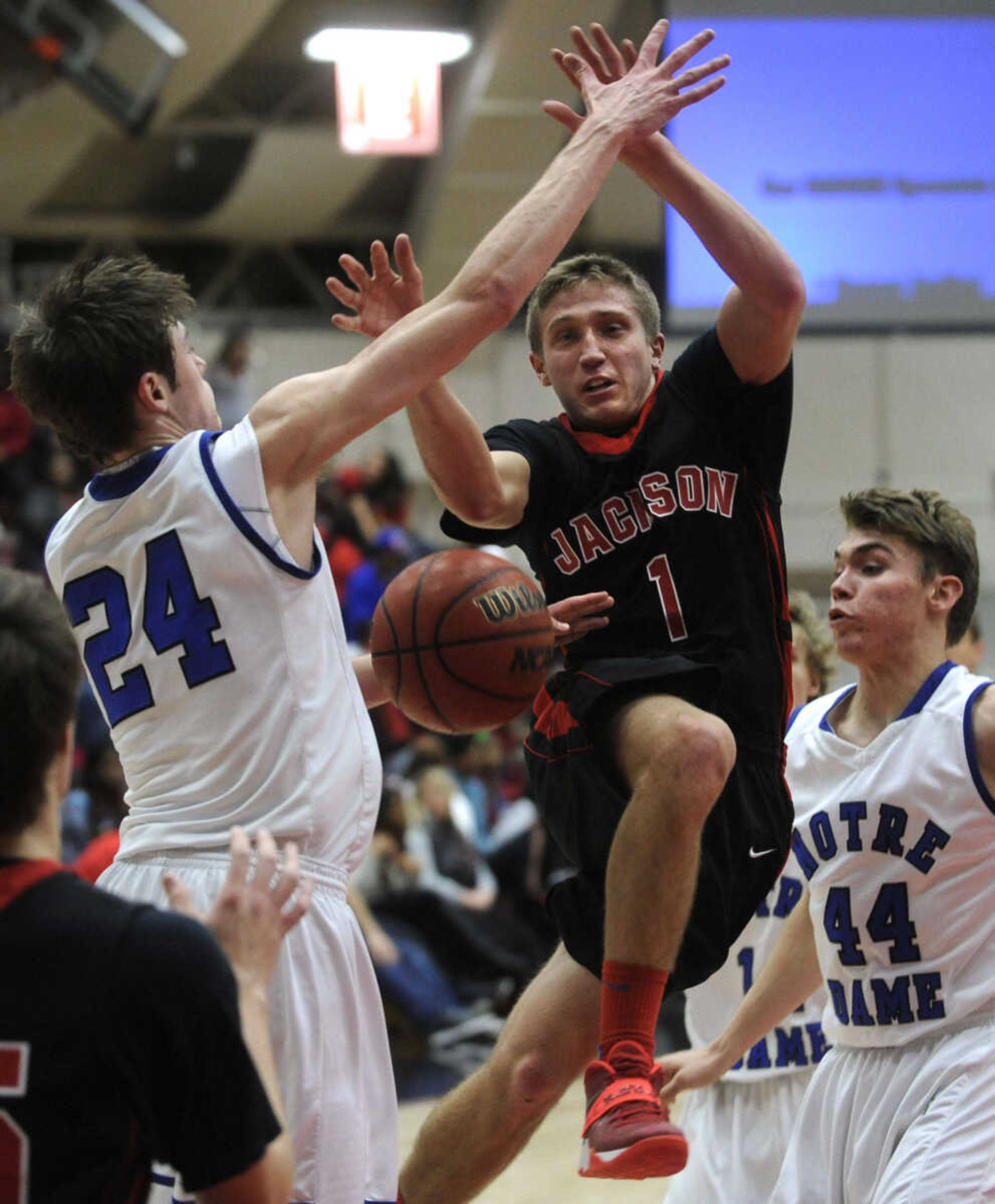 FRED LYNCH ~ flynch@semissourian.com
Jackson's Josh Daume has his shot deflected by Notre Dame's Quinn Poythress as Dean Crippen looks on during the second quarter of the championship game of the SEMO Conference Tournament Friday, Dec. 13, 2013 in Sikeston, Mo.