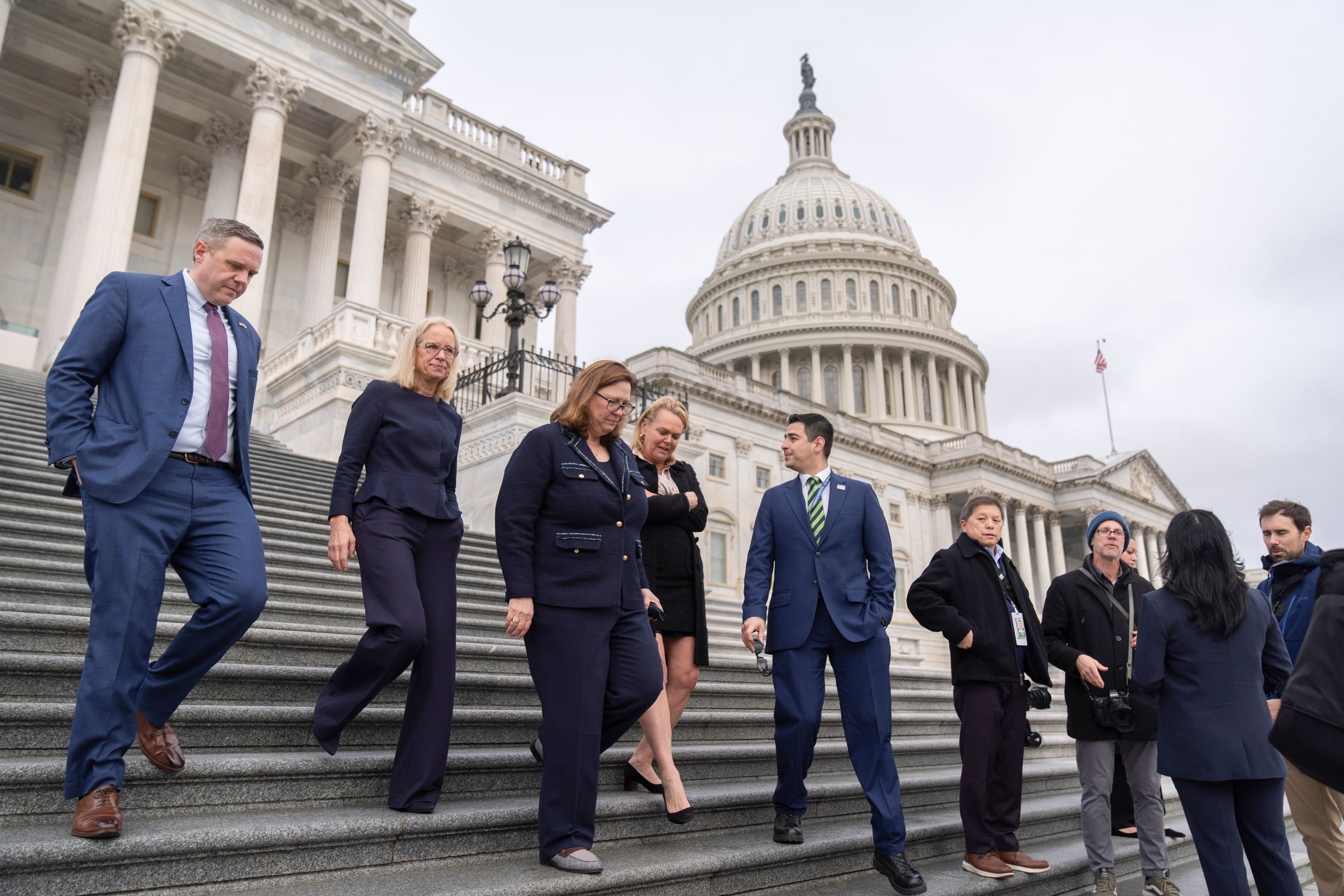 From left, Rep.-elect Jeff Hurd, R-Colo., Rep.-elect Kelly Morrison, D-Minn., Rep.-elect Julie Johnson, D-Texas, Rep.-elect April McClain Delaney, D-Md., and Rep.-elect Gabe Evans, R-Colo., walk down the steps of the Capitol, Friday, Nov. 15, 2024, in Washington. (AP Photo/Mark Schiefelbein)