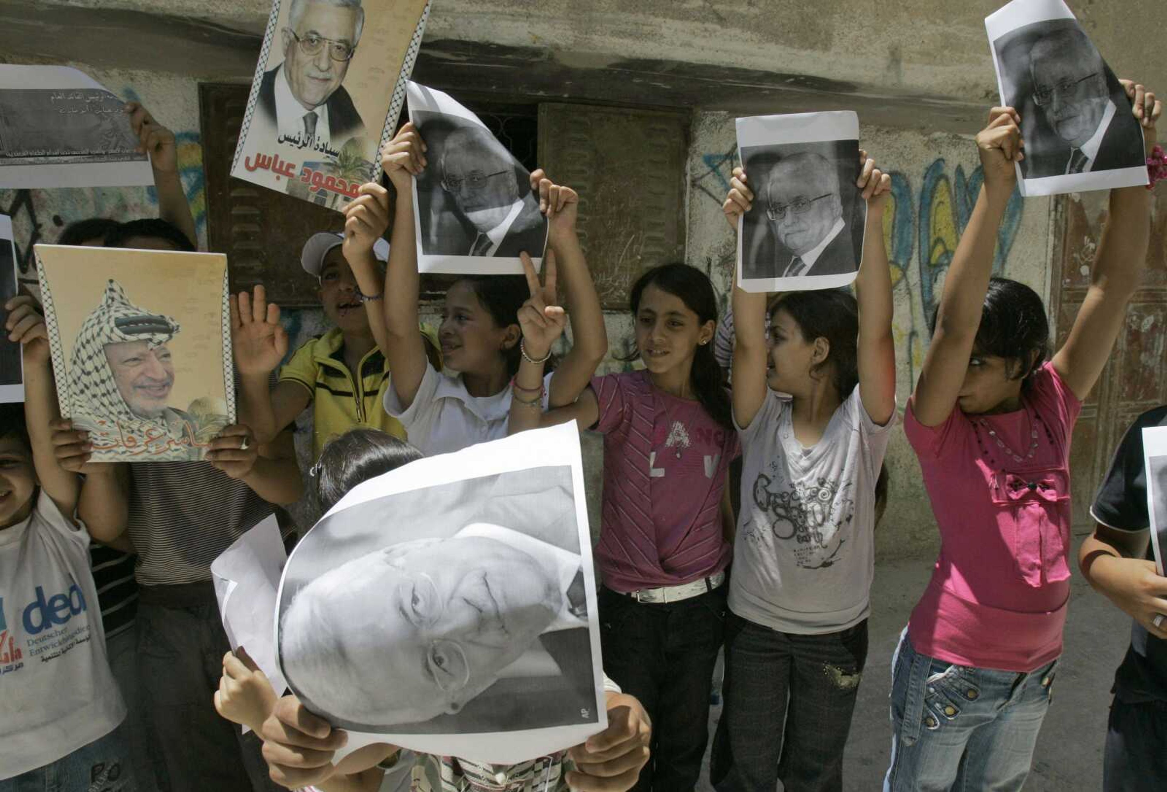 Palestinian children hold up pictures in support of Palestinian President Mahmoud Abbas on Saturday in the Balata refugee camp in the West Bank city of Nablus. (Nasser Ishtayeh ~ Associated Press)