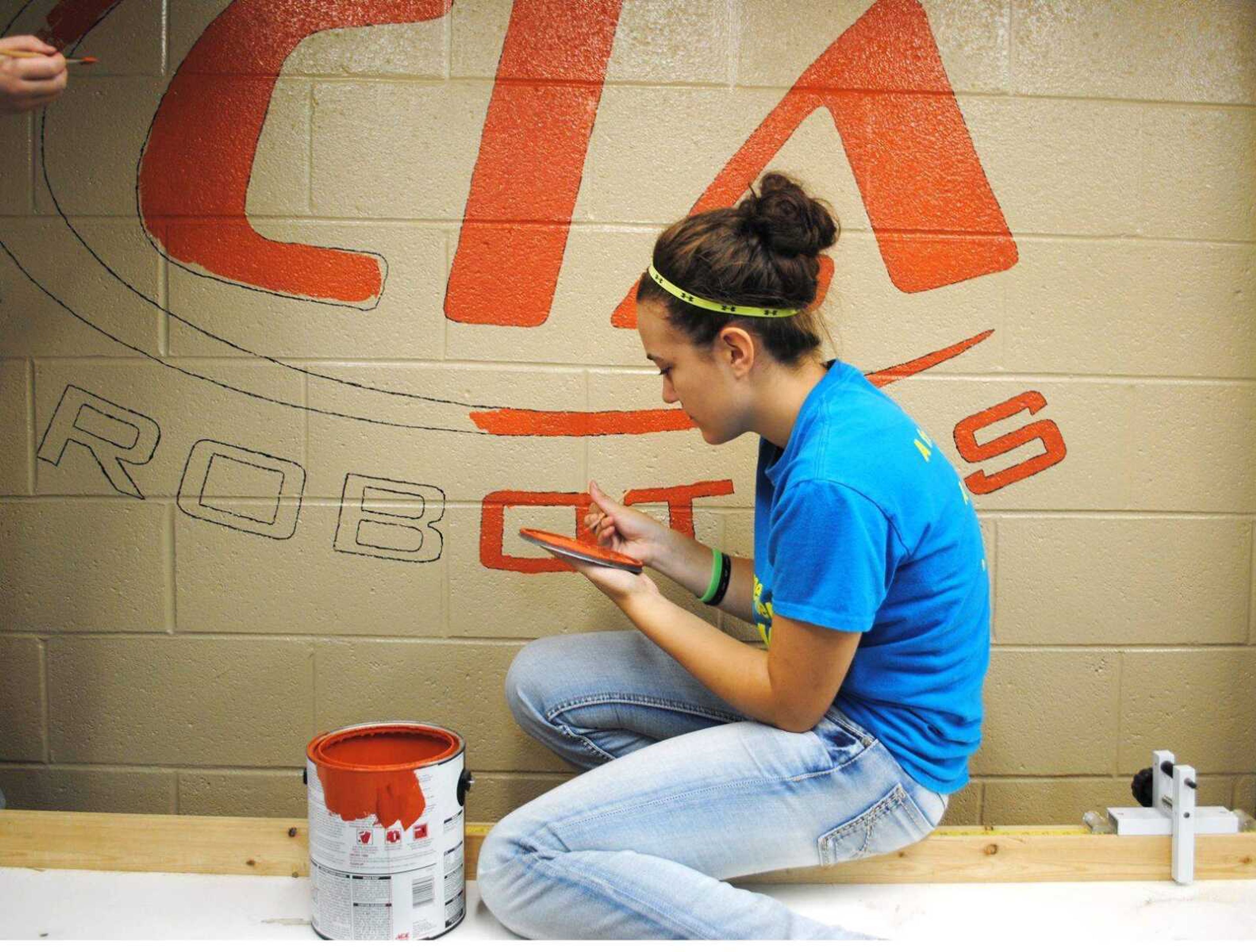 Freshman Charley Robinson paints the &#8220;CIA Robotics&#8221; logo on the freshly painted shop wall. (Submitted by Chaffee Industrial Arts &amp; Technology)