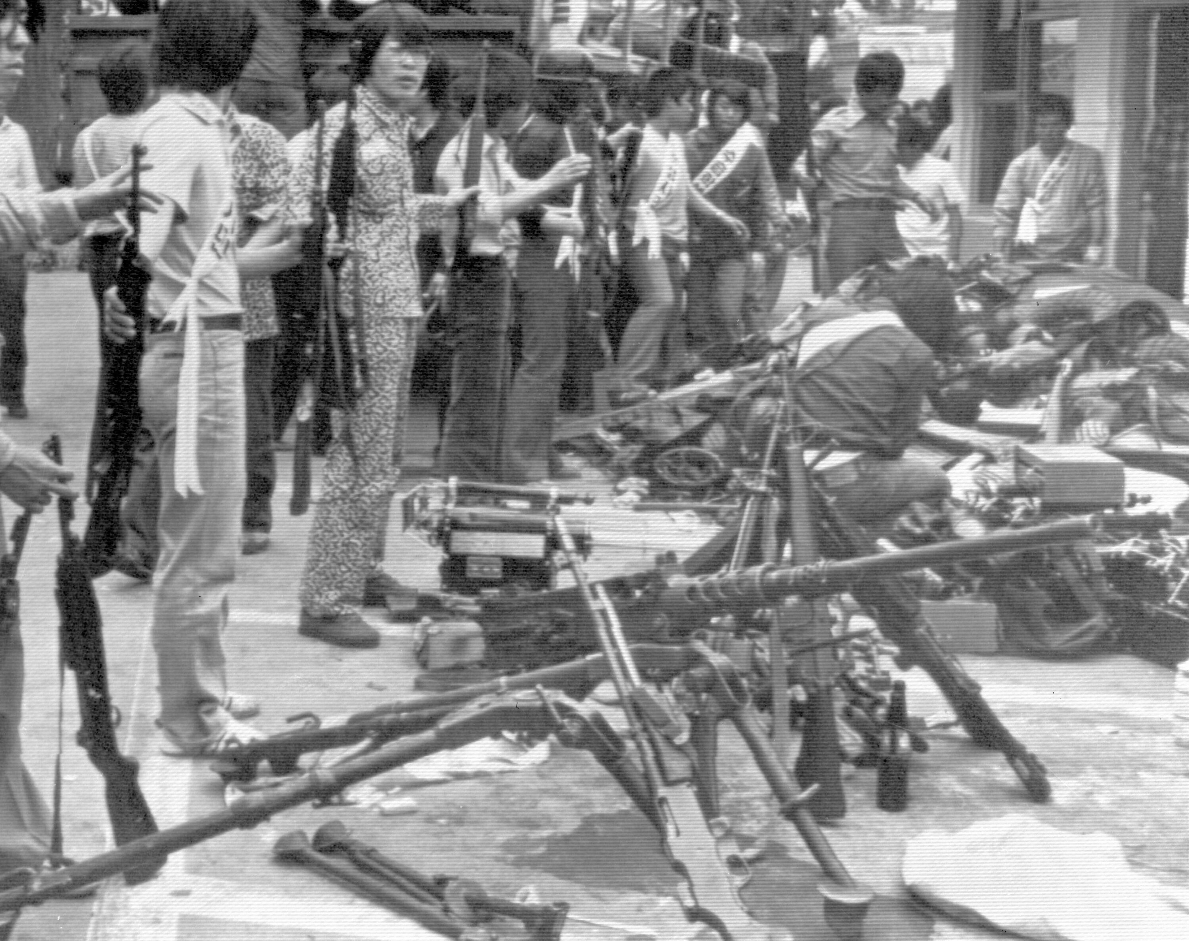 FILE- Korean student demonstrators gather with their collection of weapons, stolen from police and military, at a government building, in Gwangju (Kwangju), South Korea, May 24, 1980, during anti-government demonstrations. (AP Photo/File)