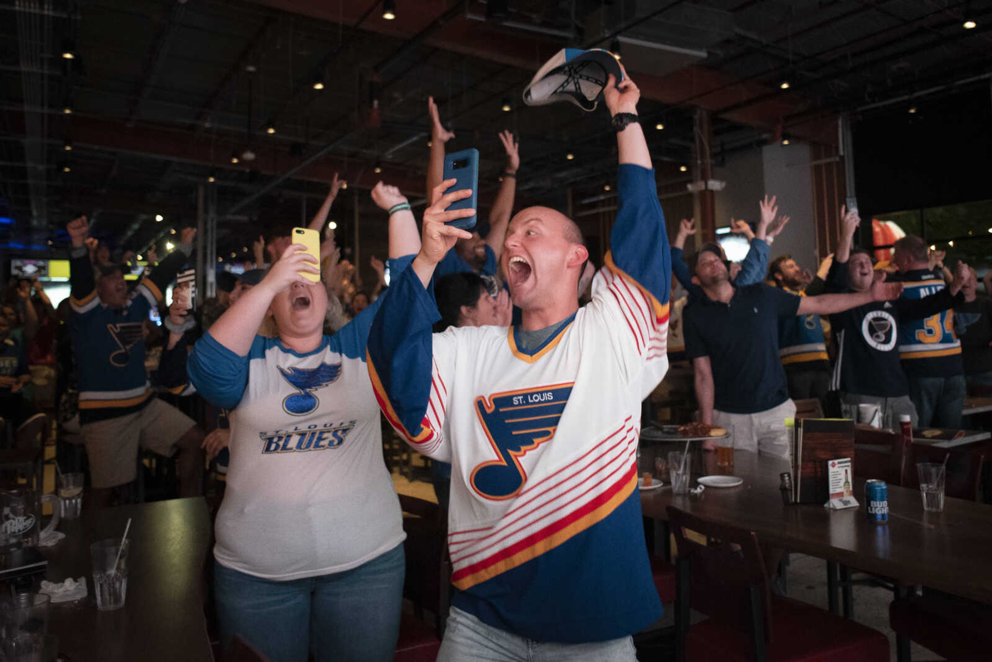 Chase Groshong of Troy, Missouri, and Madison Mingione of Perryville, Missouri, left, react to the St. Louis Blues claiming the Stanley Cup after defeating the Boston Bruins 4-1 in Game 7 on Wednesday, June 12, 2019, while watching the event at Dogwood Social House in Cape Girardeau. This was the first time the St. Louis Blues claimed the Stanley Cup in franchise history.