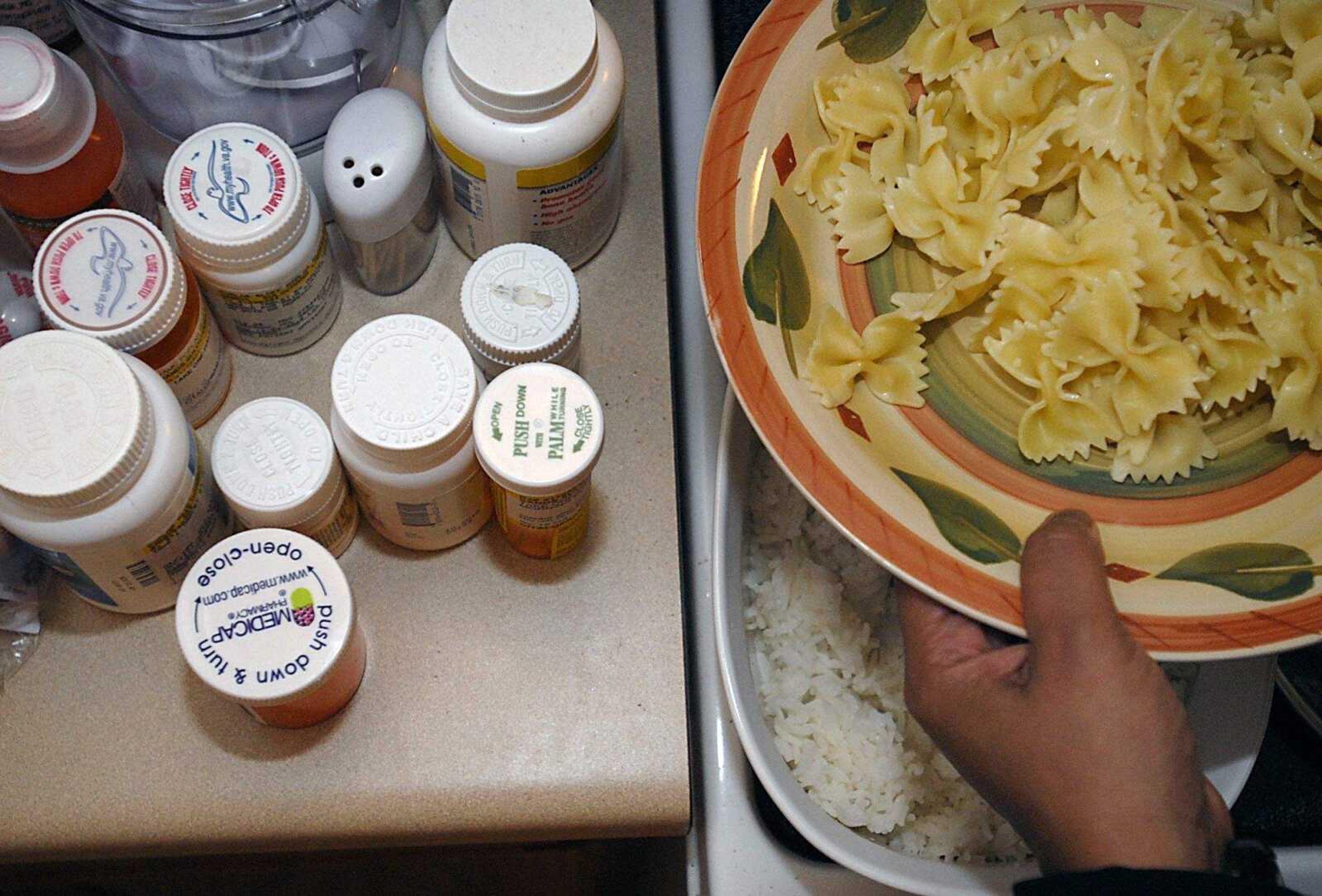 KIT DOYLE ~ kdoyle@semissourian.com
Lucky Sands served dinner as her medications sat next to the stove at her Cape Girardeau home Monday, April 21, 2008. Sands seldomly cooks at home because she lacks motivation and energy. She goes to Walter Reed Army Medical Center in May to have a variety of physical and mental issues addressed, some perhaps stemming from post-traumatic stress disorder.