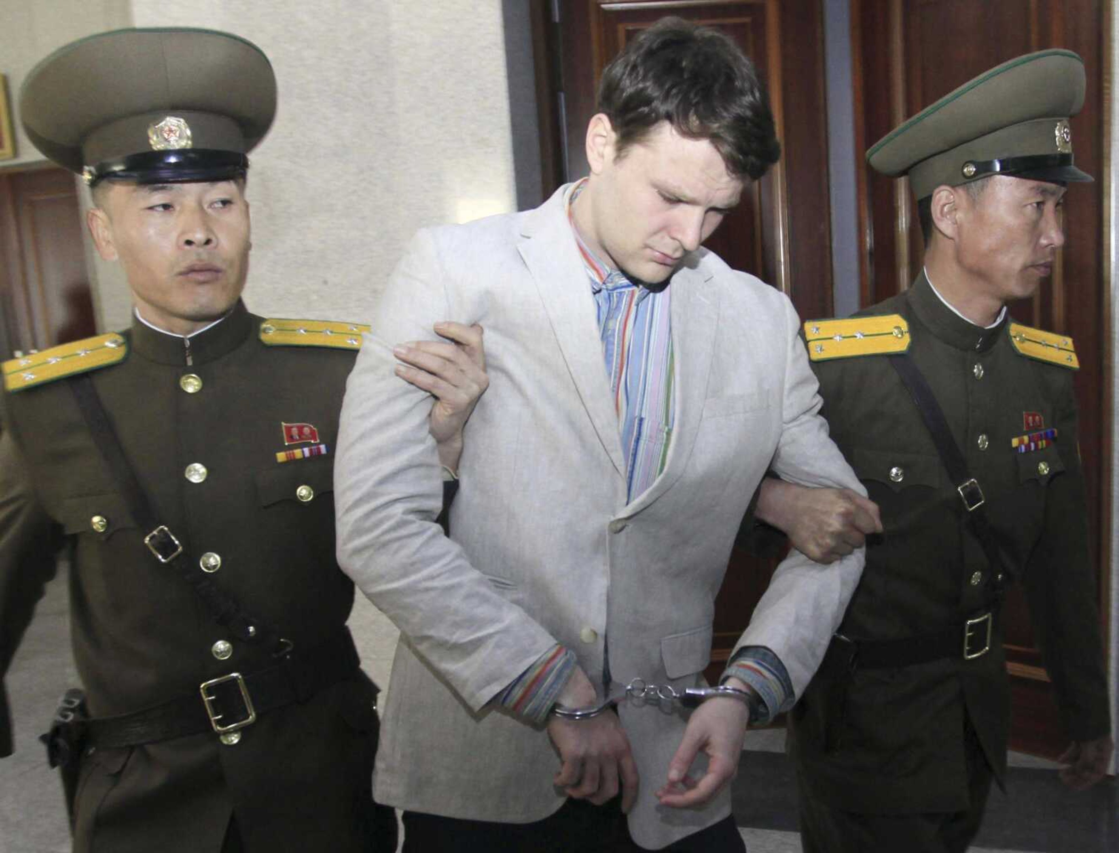 American student Otto Warmbier is escorted Wednesday at the Supreme Court in Pyongyang, North Korea. North Korea's highest court sentenced Warmbier, a 21-year-old University of Virginia undergraduate student from Wyoming, Ohio, to 15 years in prison with hard labor on Wednesday for subversion.