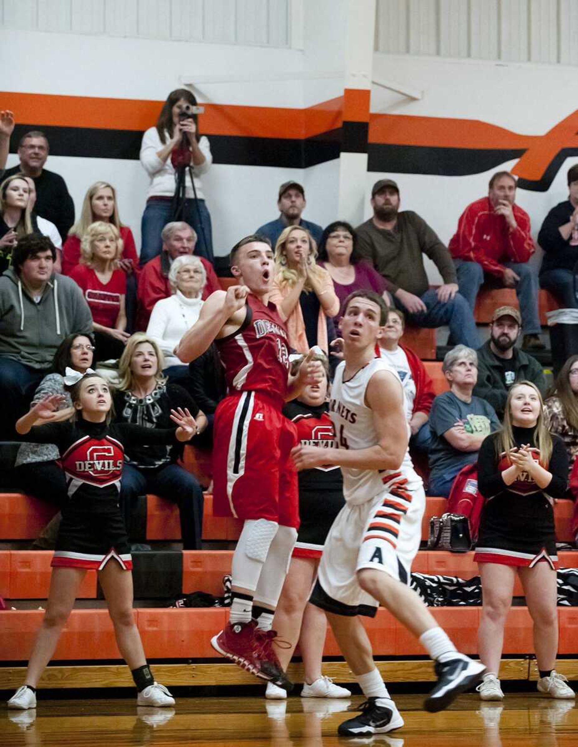 Chaffee junior Peyton Montgomery, left, Advance senior Lane Below and Chaffee cheerleaders and fans watch as Montgomery&#8217;s 3-pointer goes in giving the Red Devils a one-point lead with less than a minute left in the game Tuesday in Advance, Mo. Advance won 76-72. (Adam Vogler)