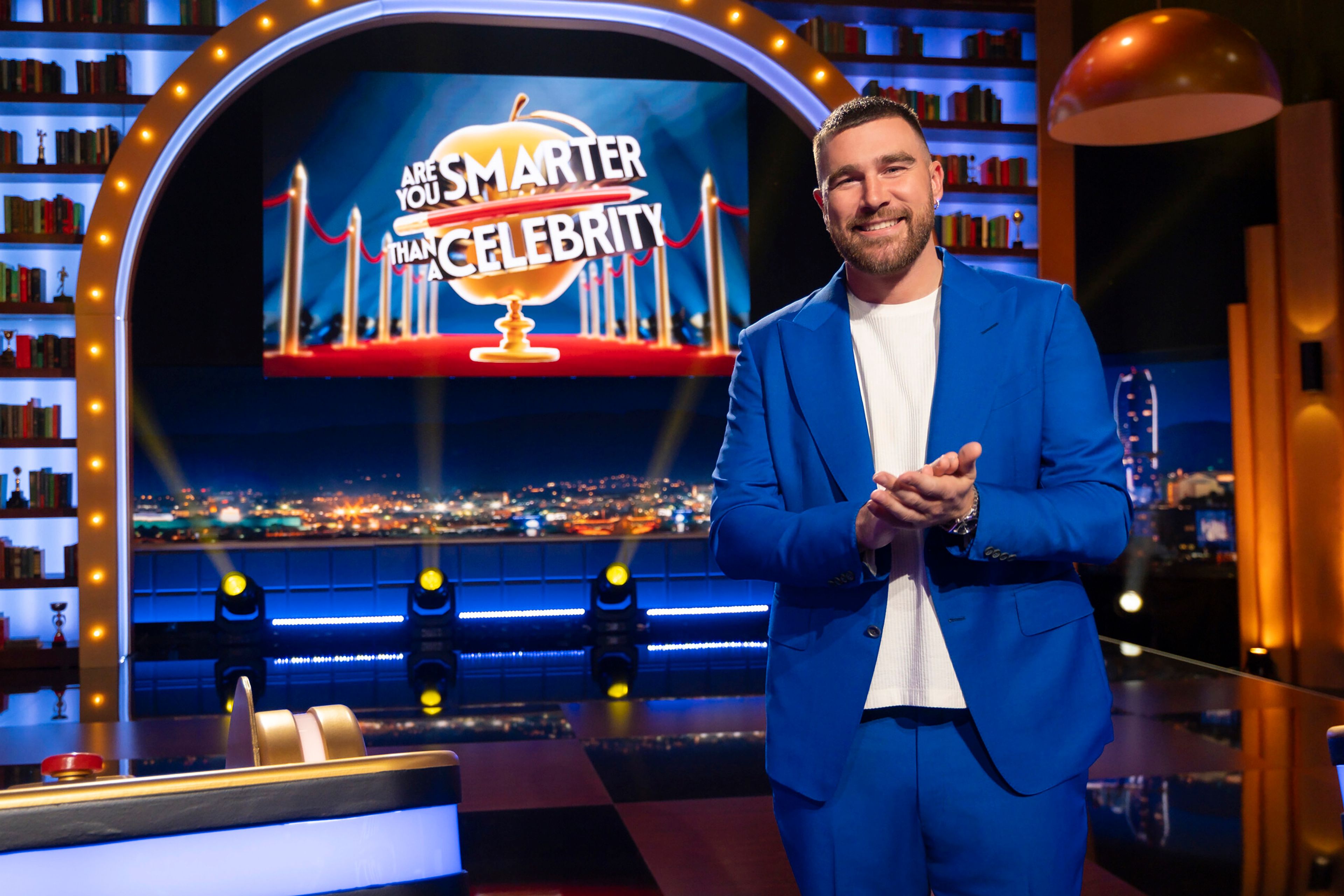 This image released by Prime Video shows NFL football player Travis Kelce, of the Kansas City Chiefs, on the set of the new game show "Are You Smarter Than a Celebrity." (Adam Rose/Prime Video via AP)