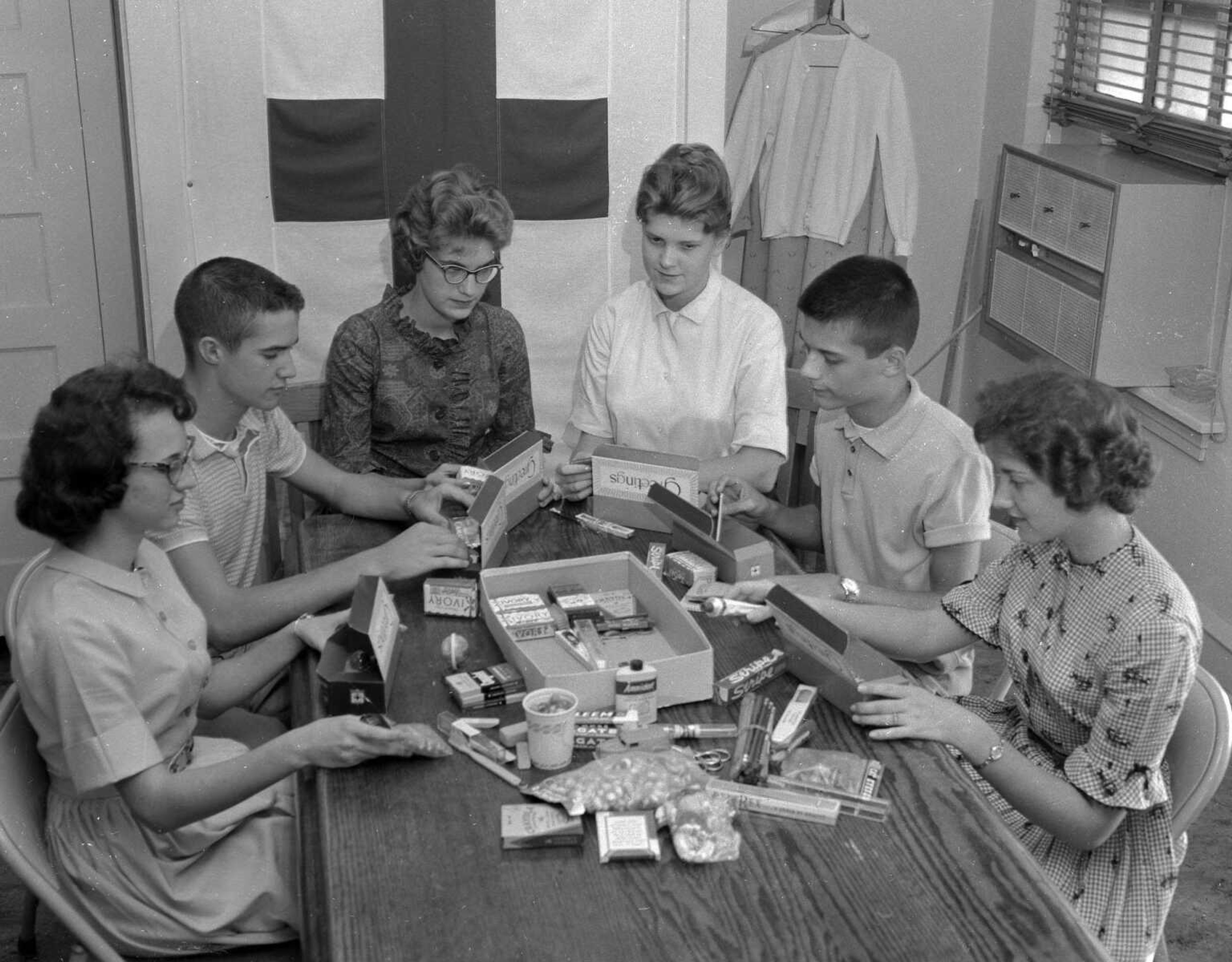 Sept. 26, 1961 Southeast Missourian.
Junior Red Cross members from high schools are shown doing their part preparing gift packages for victims in Texas of the recent hurricane Carla. Representing the various city schools, the youngsters are preparing boxes of needed supplies. From the left, Ellen Hartman of Cape Central, Darrell Schuette of Jackson, Mary Jo Kiehne of Notre Dame, Barbara Little of Central, Bob Wulff of Jackson and Frances Ann Aug of Notre Dame. (G.D. Fronabarger/Southeast Missourian archive)