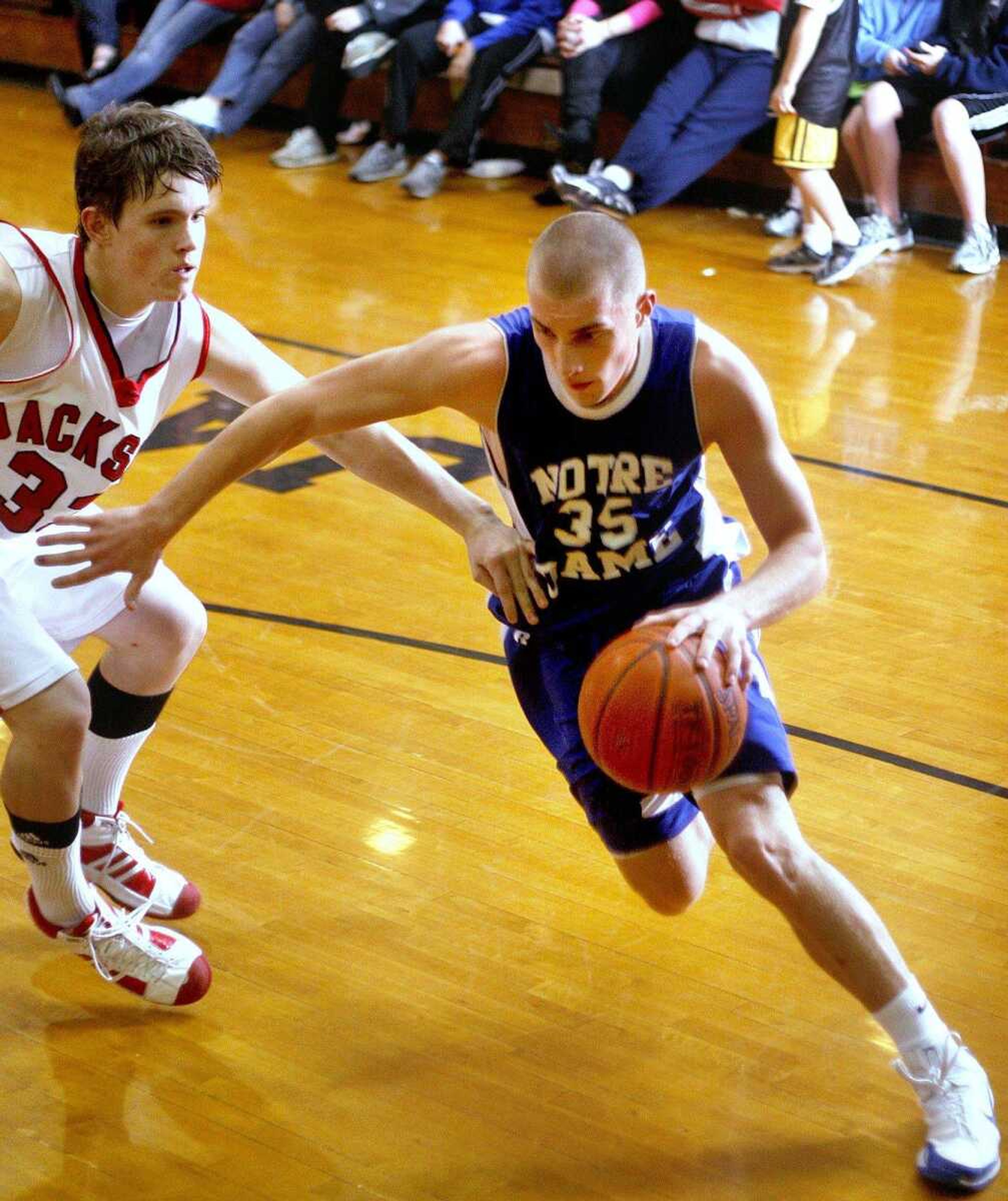 ELIZABETH DODD ~ edodd@semissourian.com
Notre Dame's Joseph Tolbert, right, makes a drive past Jackson's Bobby Clark in the third quarter of a Notre Dame win 69-52 Friday night at Jackson.