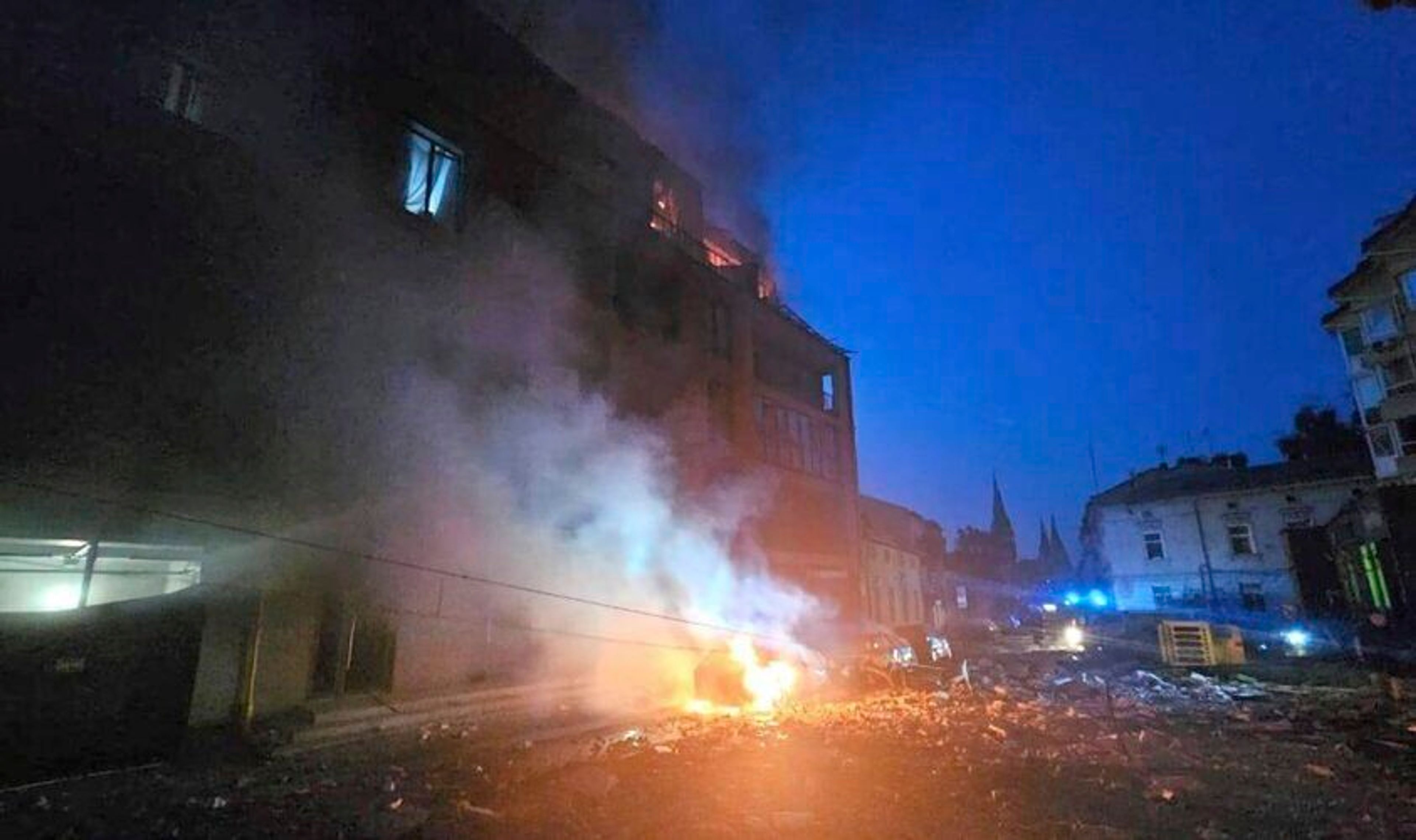 In this photo provided by the Lviv City Council, a car burns near a residential building damaged by a Russian strike in Lviv, Ukraine, Wednesday, Sept. 4, 2024.. (Lviv City Council via AP)