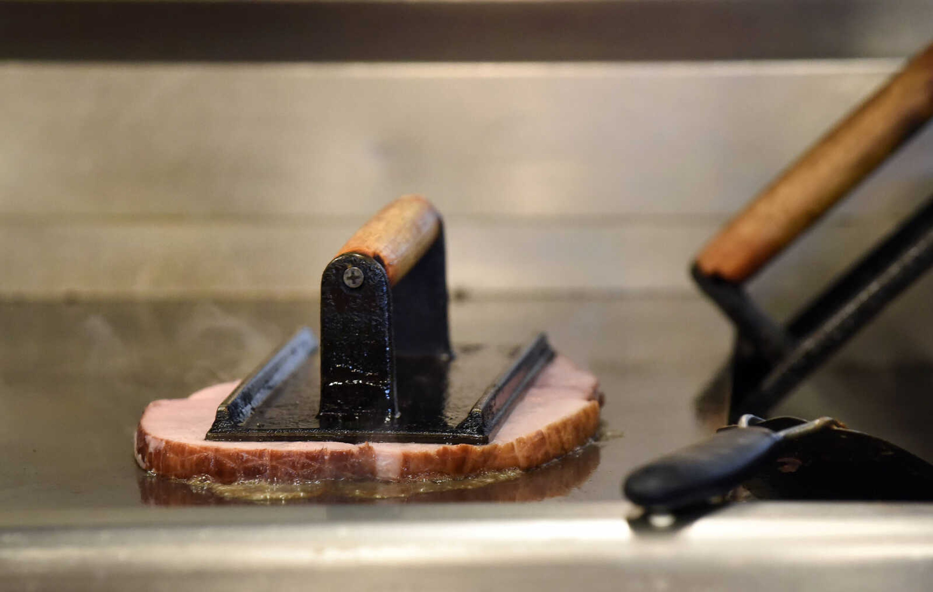 A ham steak cooks on the griddle at the Pie Bird Cafe in Jackson.