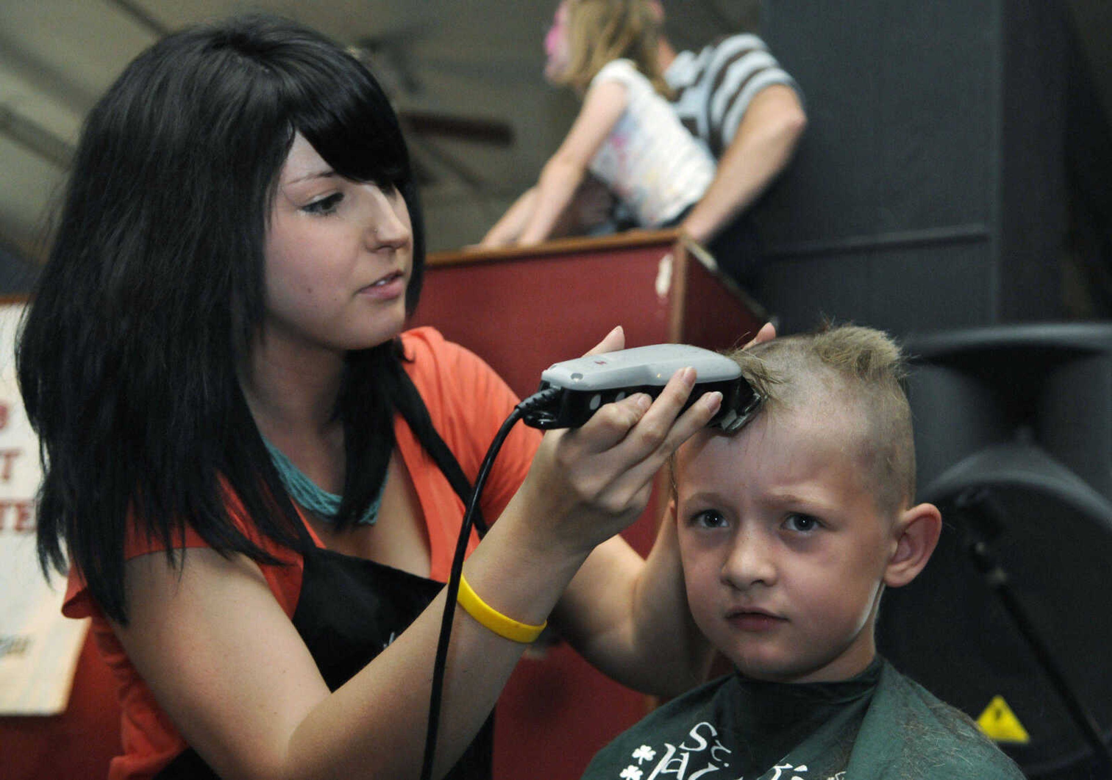 KRISTIN EBERTS ~ keberts@semissourian.com

Melissa King of JCPenney Salon shaves the head of Tony Seabaugh, 8,  during the St. Baldrick's event at Buckner Brewing Company in Cape Girardeau, Mo., on Saturday, April 24, 2010. The twenty-five area participants in the event raised over $9,000 collectively before shaving their heads in front of family and friends to benefit the St. Baldrick's Foundation for child cancer research.