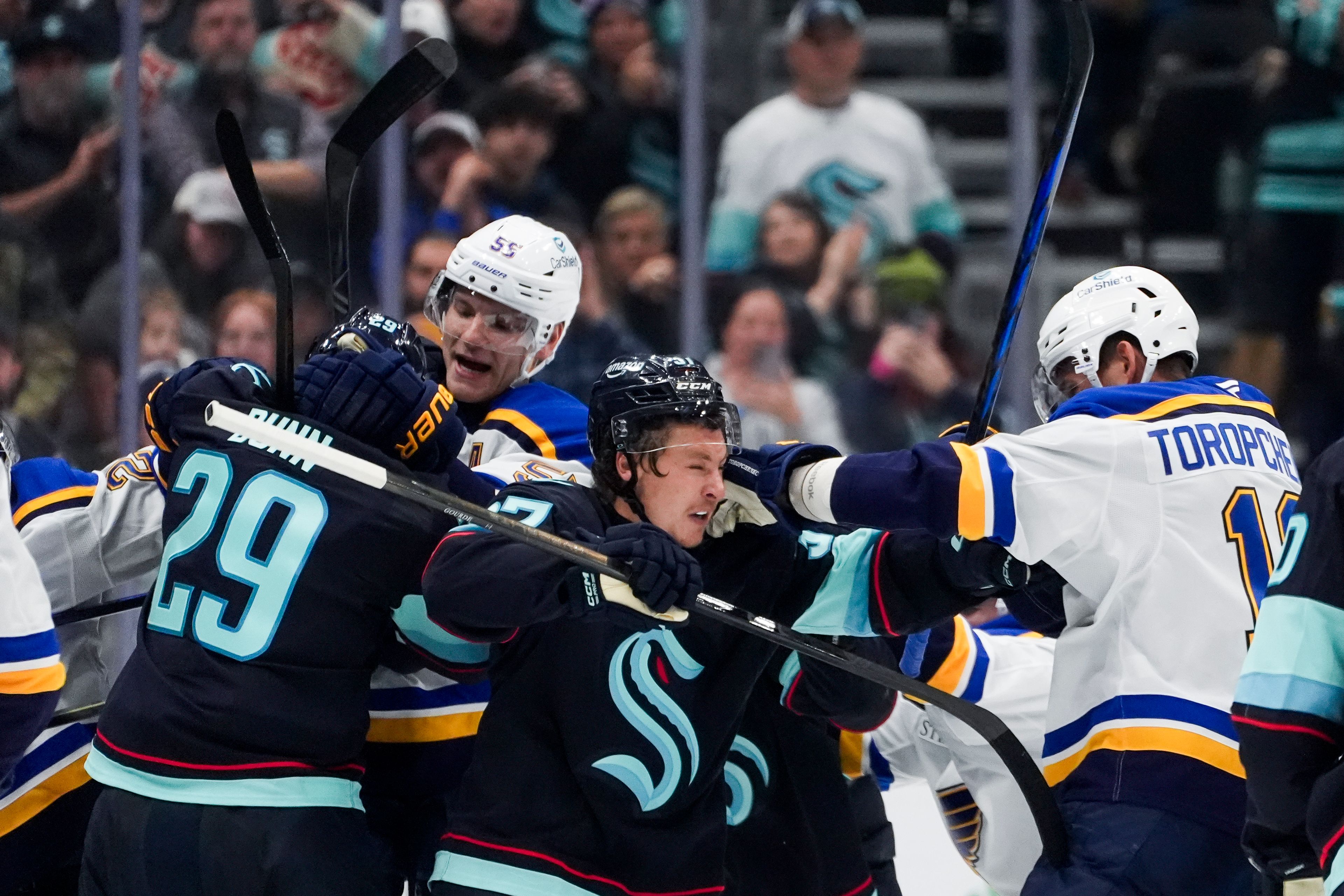 Seattle Kraken defenseman Vince Dunn (29) fights with St. Louis Blues defenseman Colton Parayko, left facing, as Kraken center Yanni Gourde, center, fights with Blues right wing Alexey Toropchenko (13) during the second period of an NHL hockey game Tuesday, Oct. 8, 2024, in Seattle. (AP Photo/Lindsey Wasson)