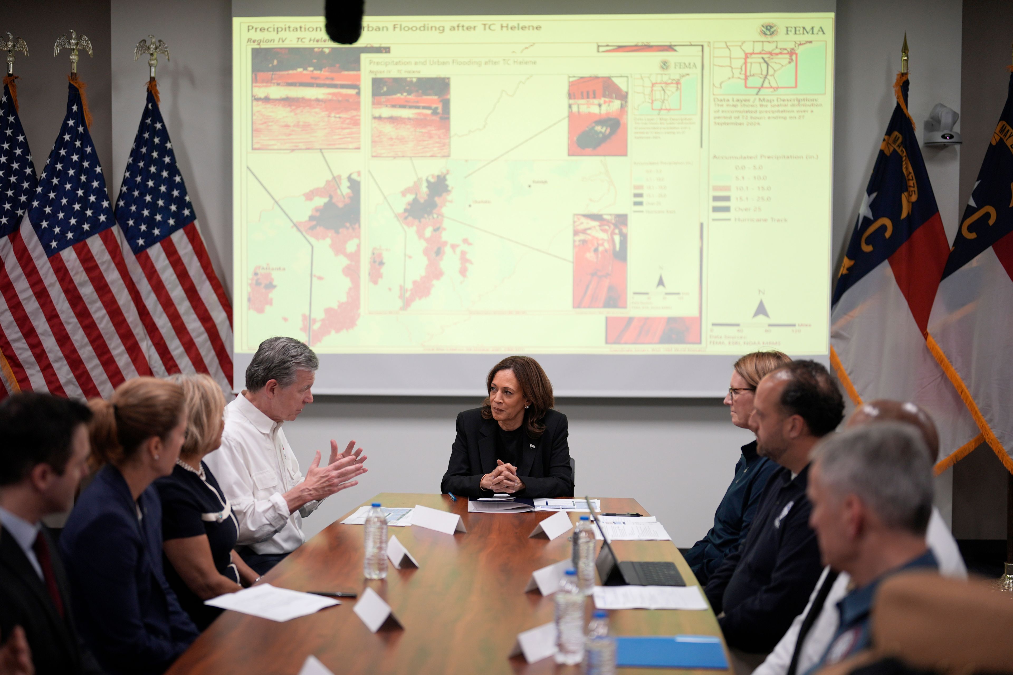 Democratic presidential nominee Vice President Kamala Harris, center right, receives a briefing from North Carolina Gov. Roy Cooper, center left, on the damage from Hurricane Helene, Saturday, October 5, 2024, in Charlotte, N.C. (AP Photo/Chris Carlson)