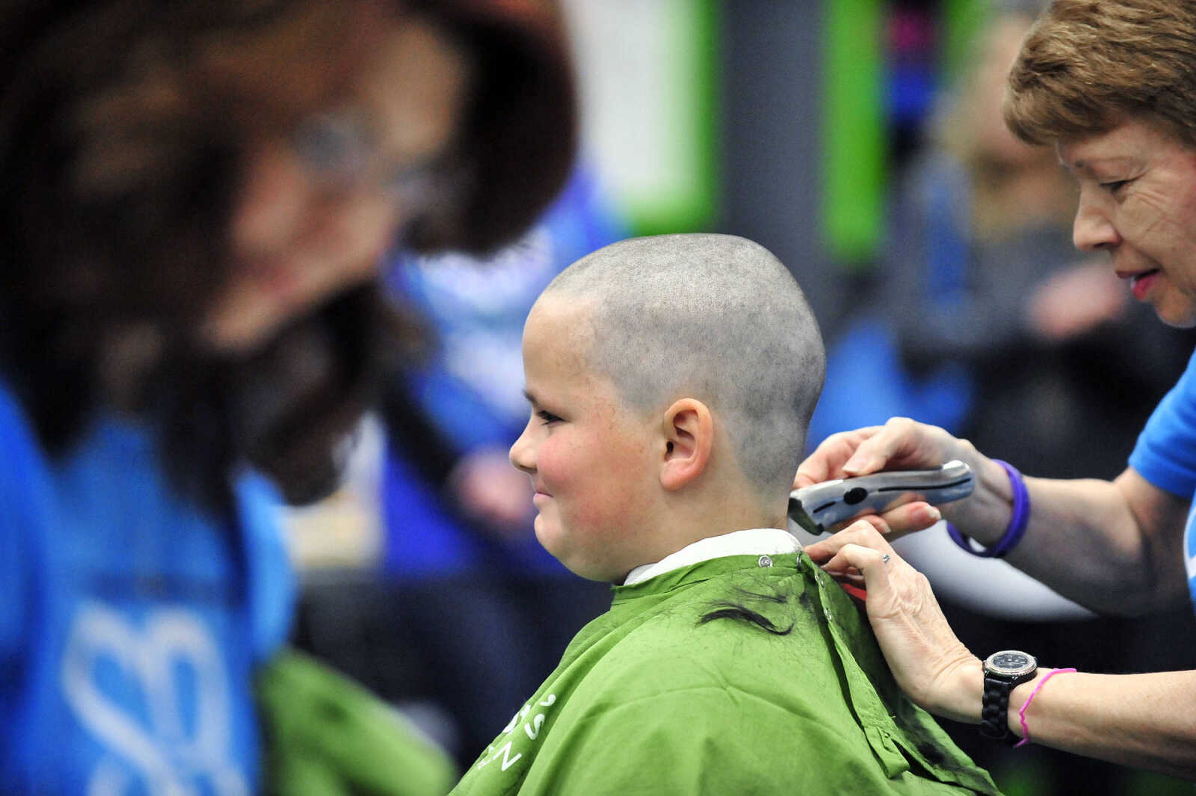 Matthew Brees, 10, grins as Jean McLane shaves his head on Saturday, March 4, 2017, during the St. Baldrick's Foundation fundraiser at Old Orchard CrossFit in Jackson.