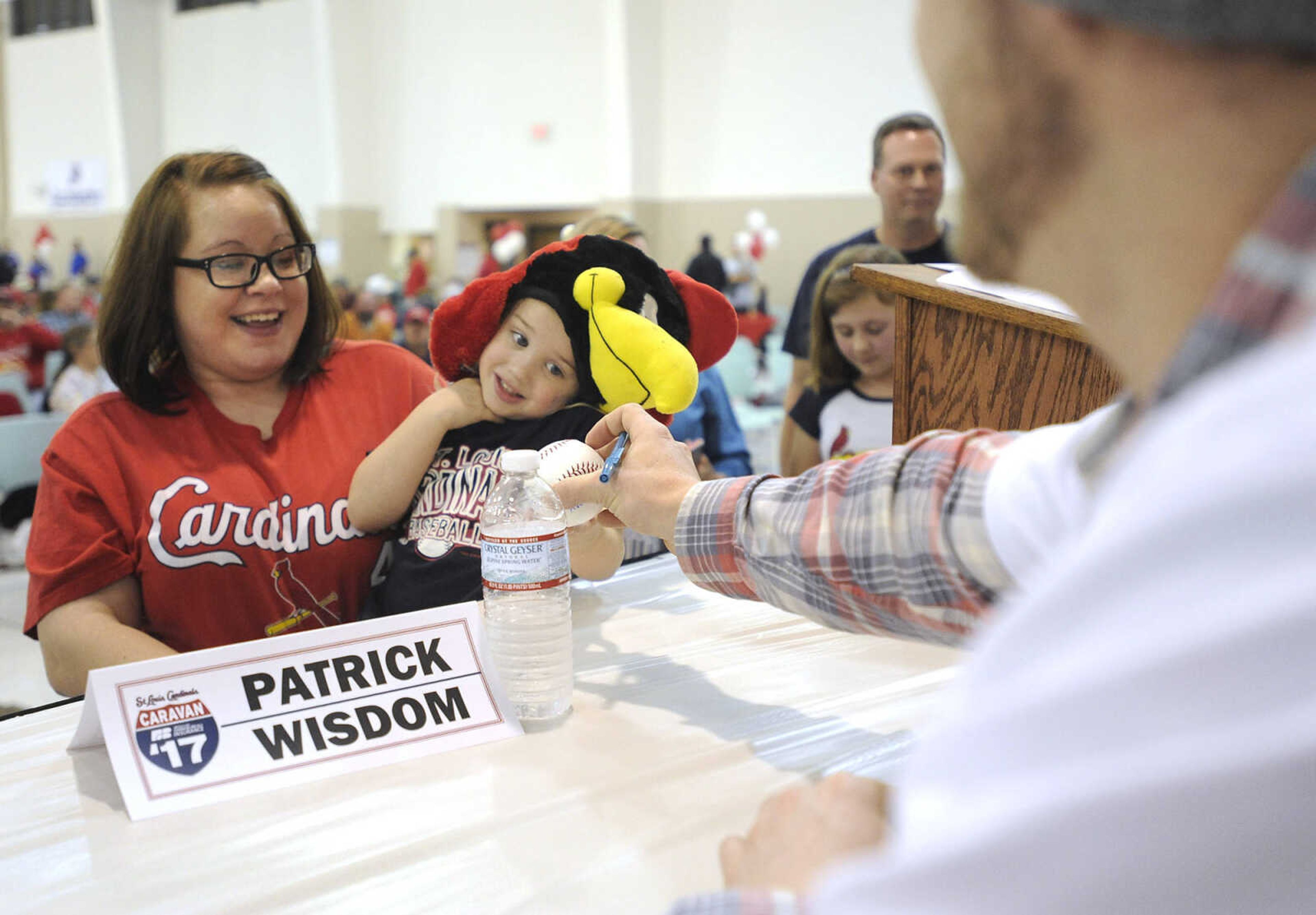 FRED LYNCH ~ flynch@semissourian.com
Willow Burnes and his mother, Courtney Burnes, get a baseball autographed by St. Louis Cardinals prospect Patrick Wisdom during the Cardinals Caravan on Monday, Jan. 16, 2017 at the Osage Centre.